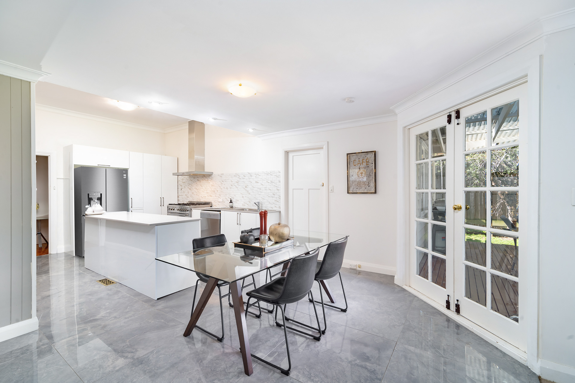 White kitchen and dining area with glass-panelled doors