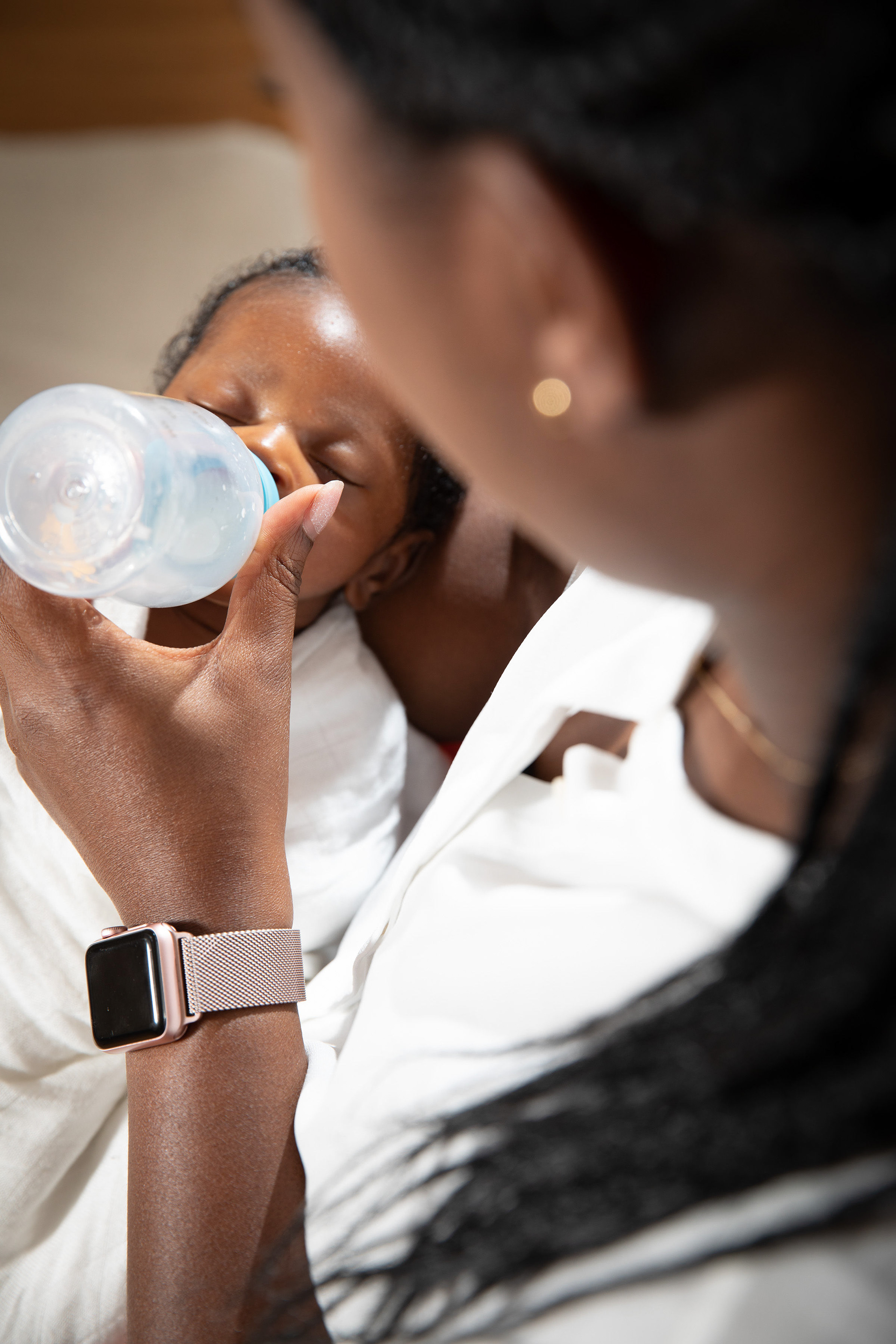 Parent feeding a baby with a bottle