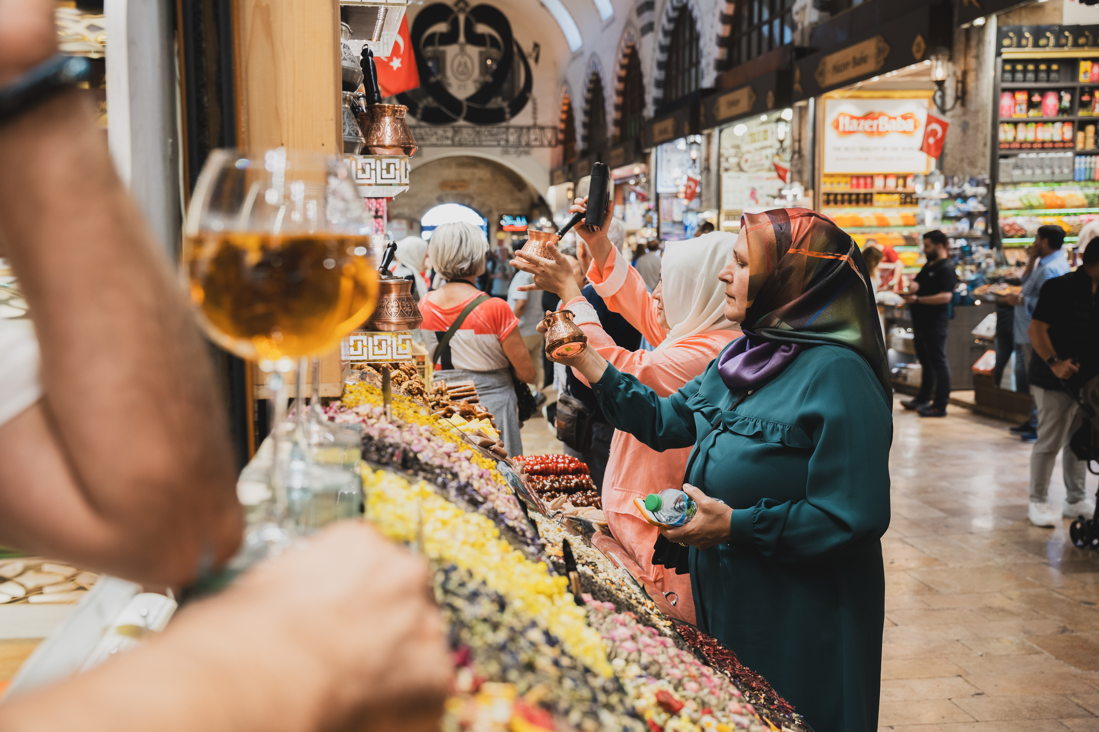 Customers and vendors at a colourful market stall