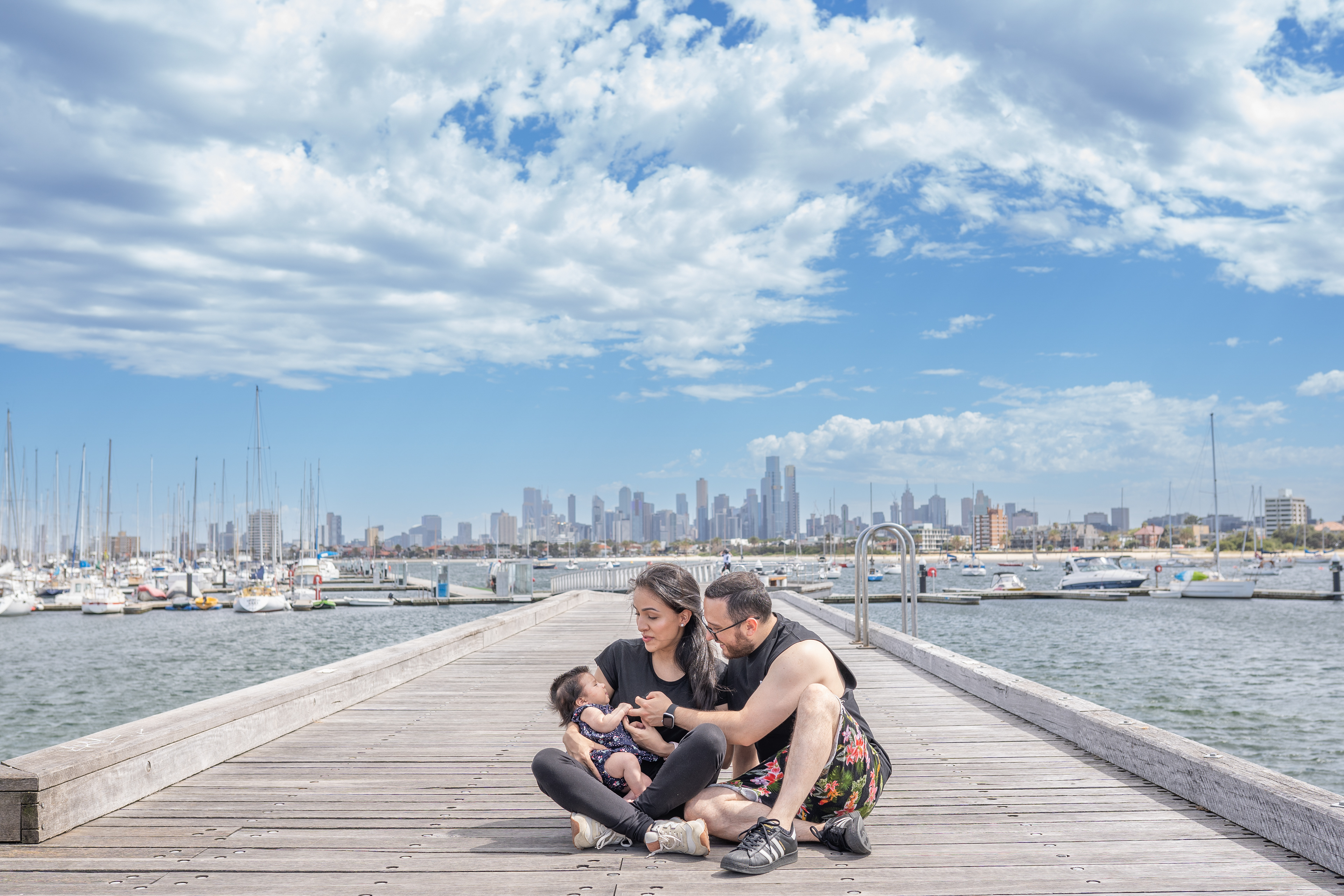 Family seated together on a waterfront deck