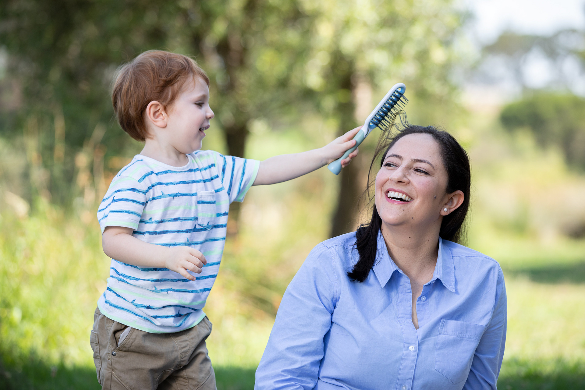 Parent lifting a child outdoors