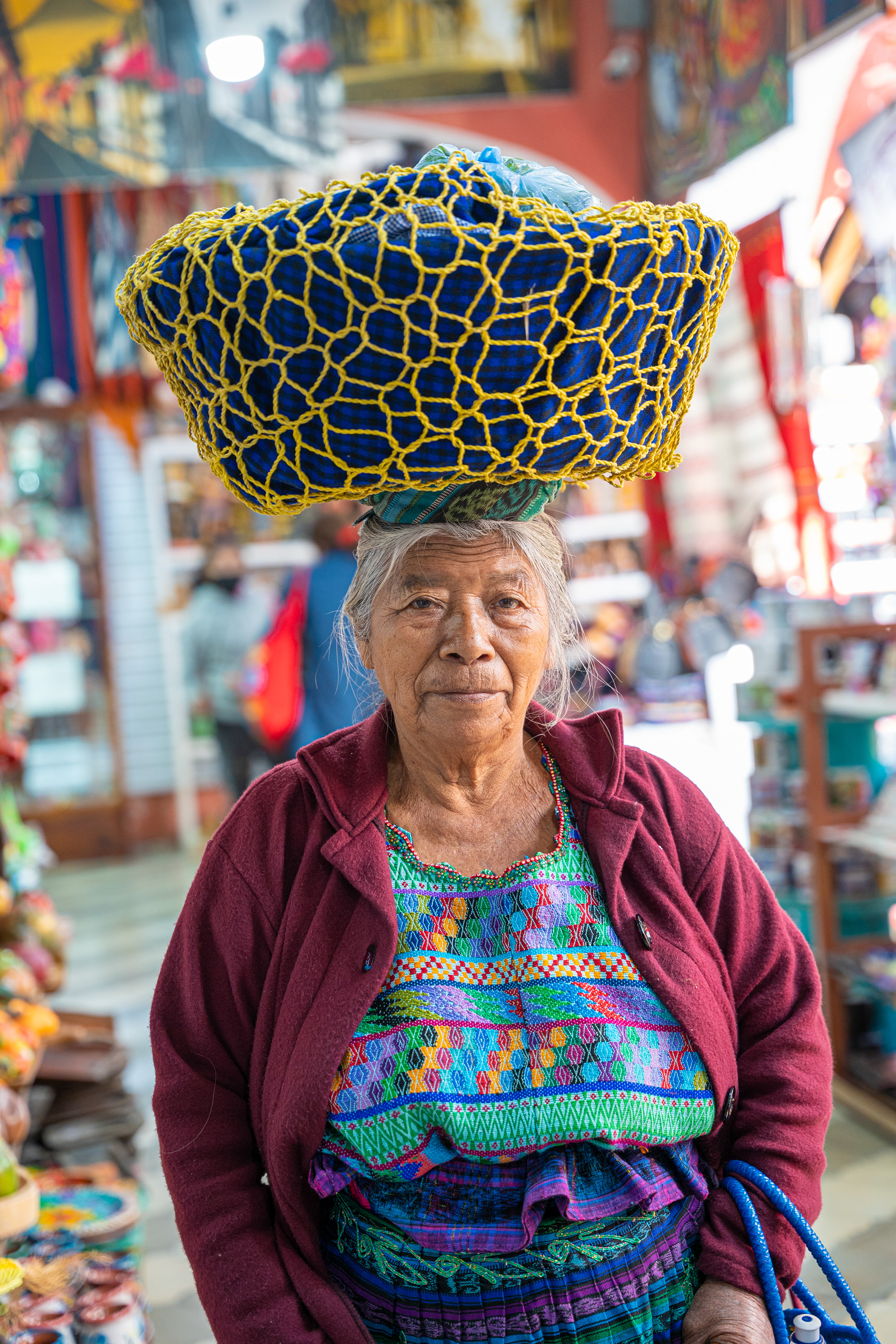Market vendor carrying a woven basket on their head