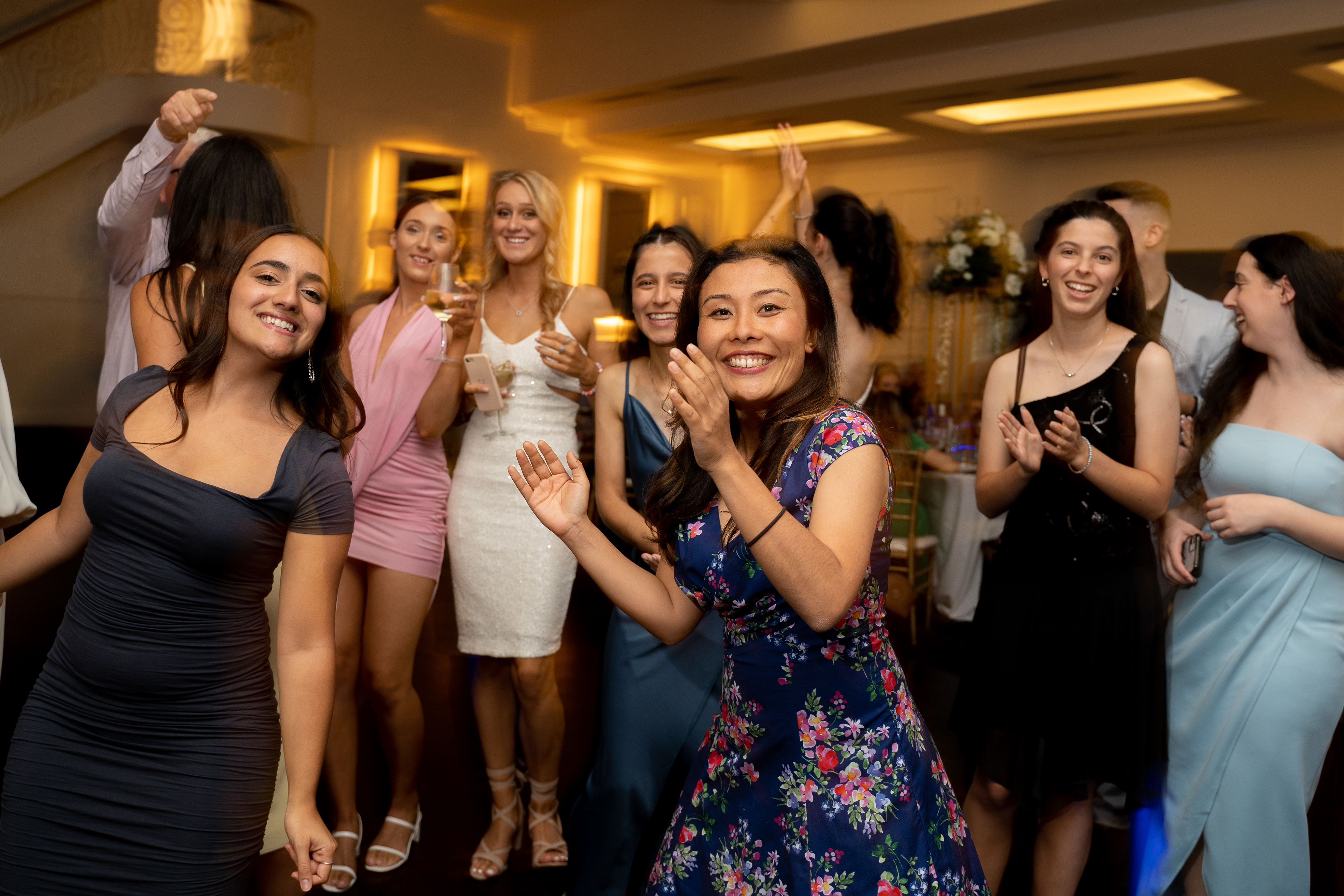 Group of guests smiling and posing at an evening event