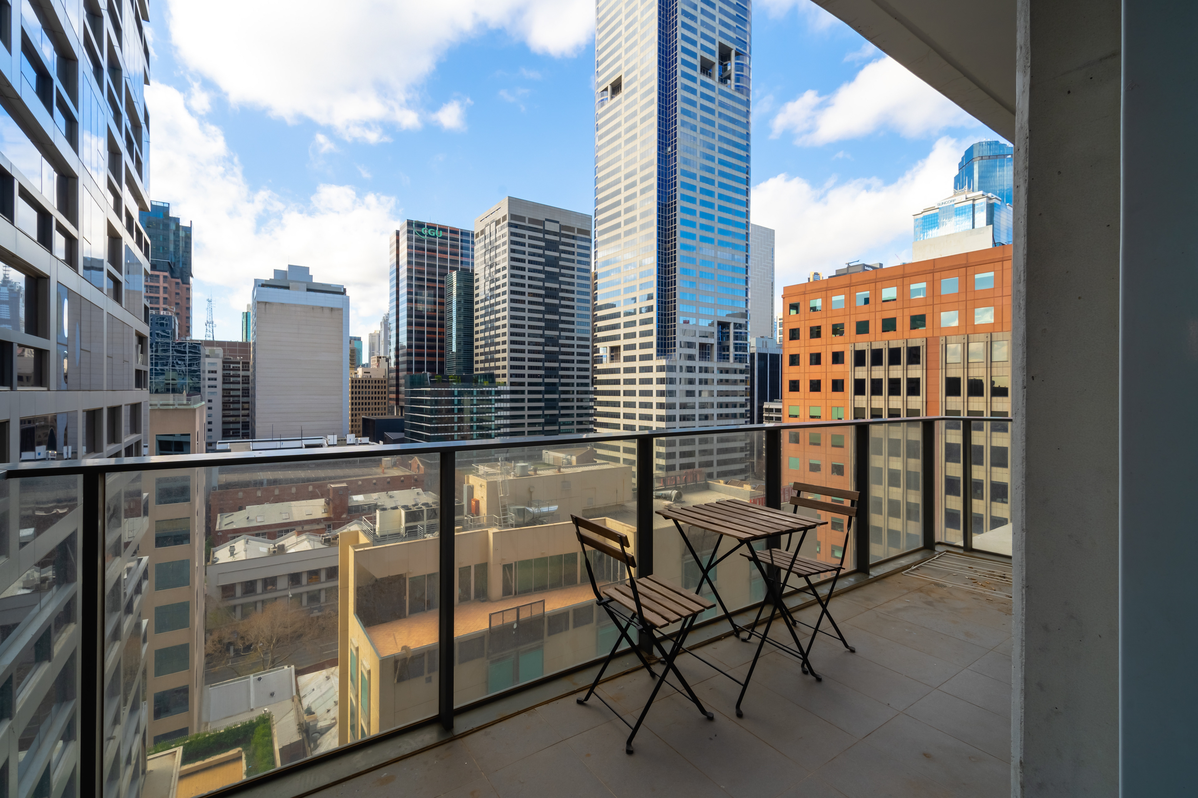 Apartment balcony with a small outdoor table and city views
