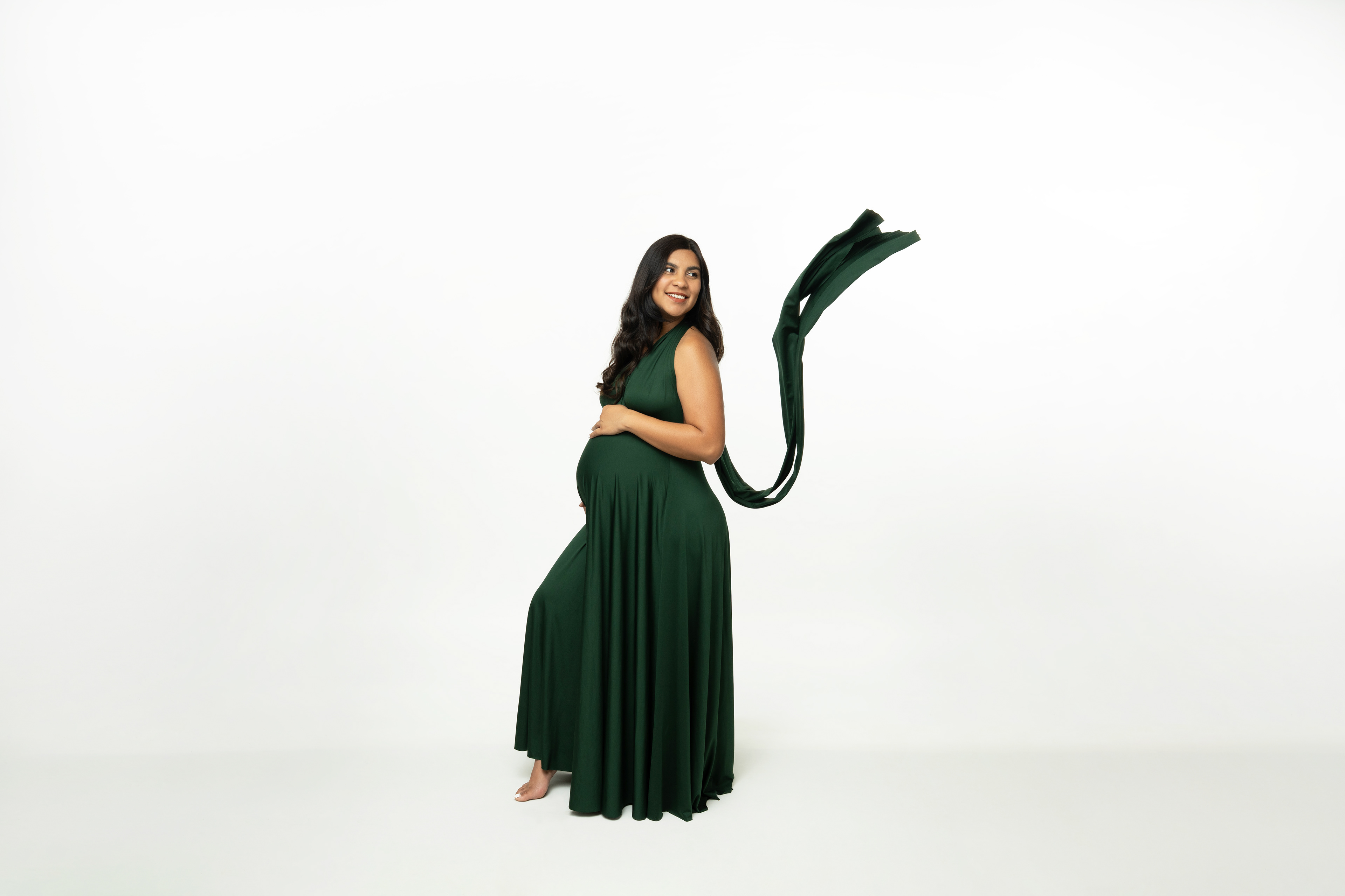 Portrait in a flowing dark green skirt with arms extended