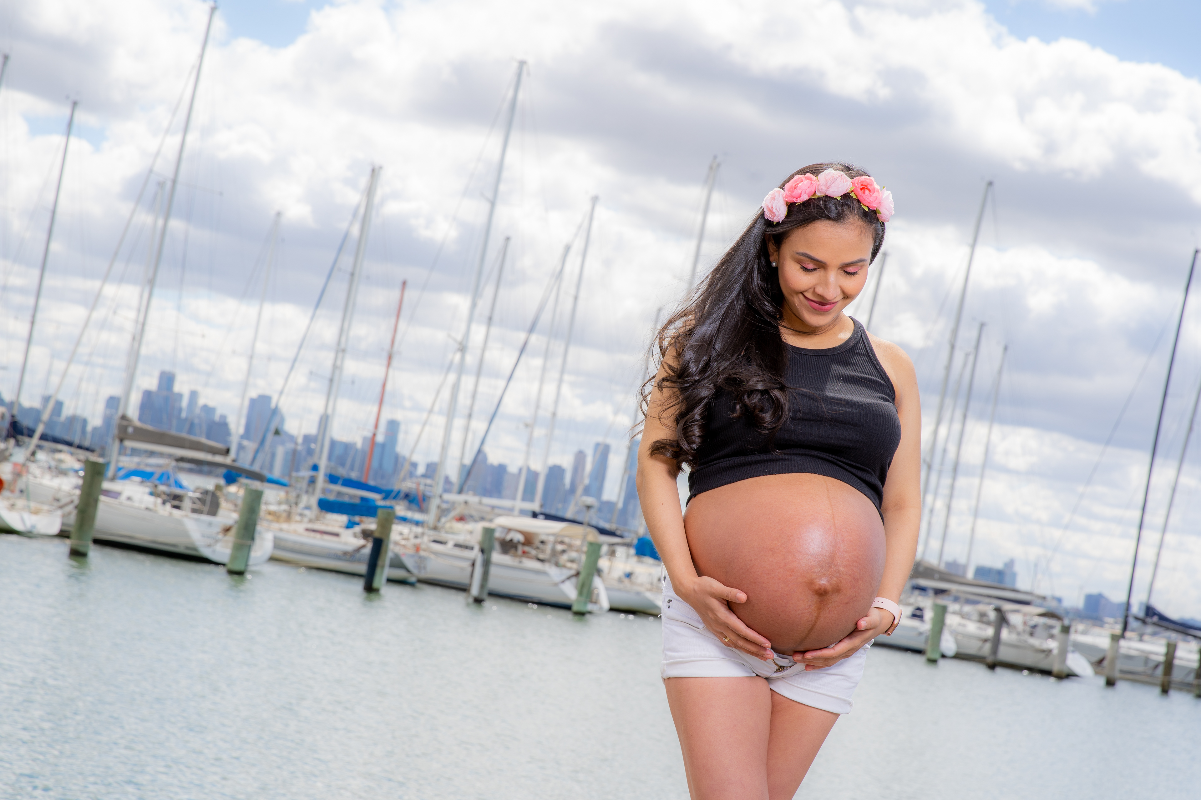 Maternity portrait beside the beach under a cloudy sky