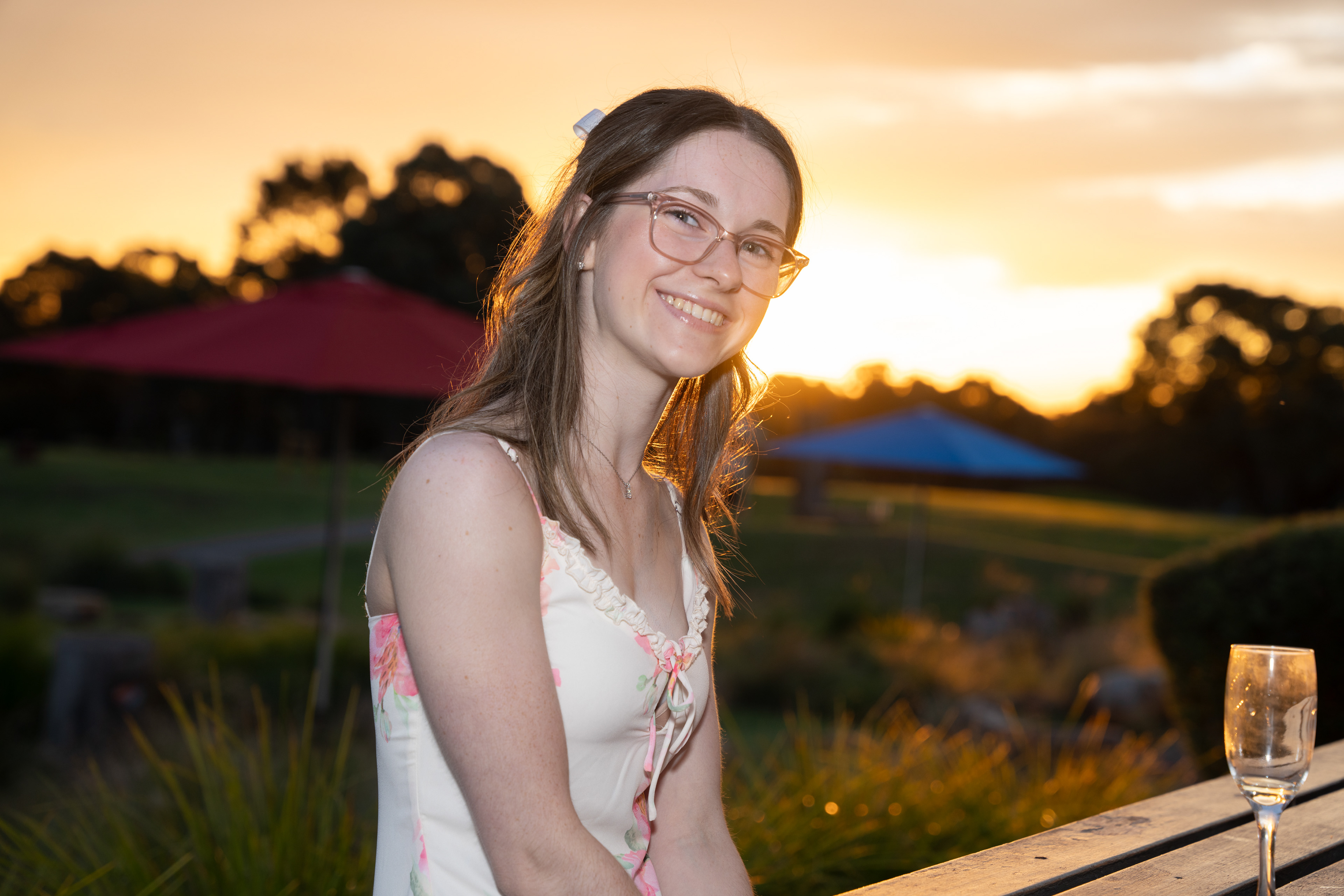 Outdoor portrait of a guest in a pink dress at sunset