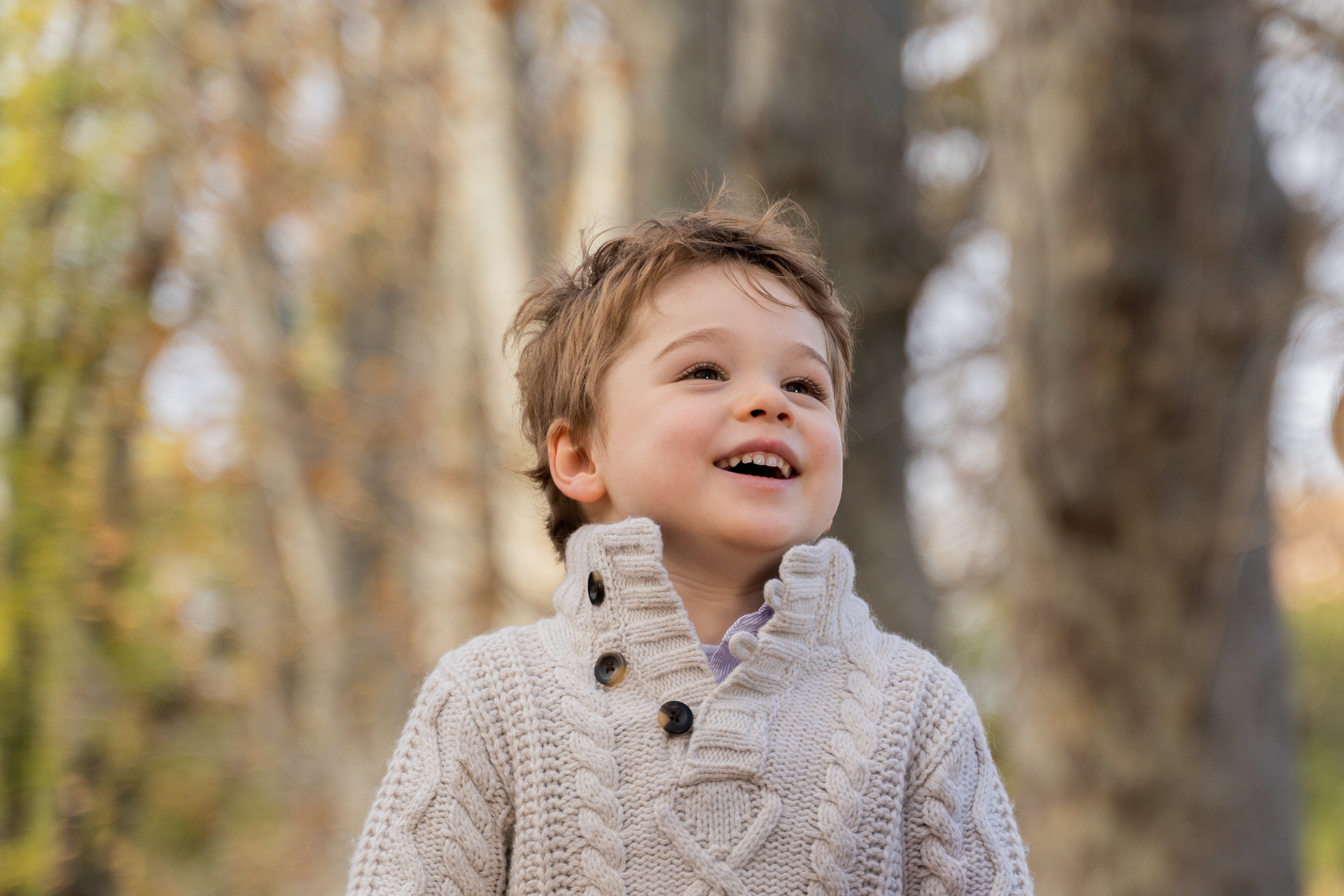 Baby in a white outfit during an outdoor portrait session