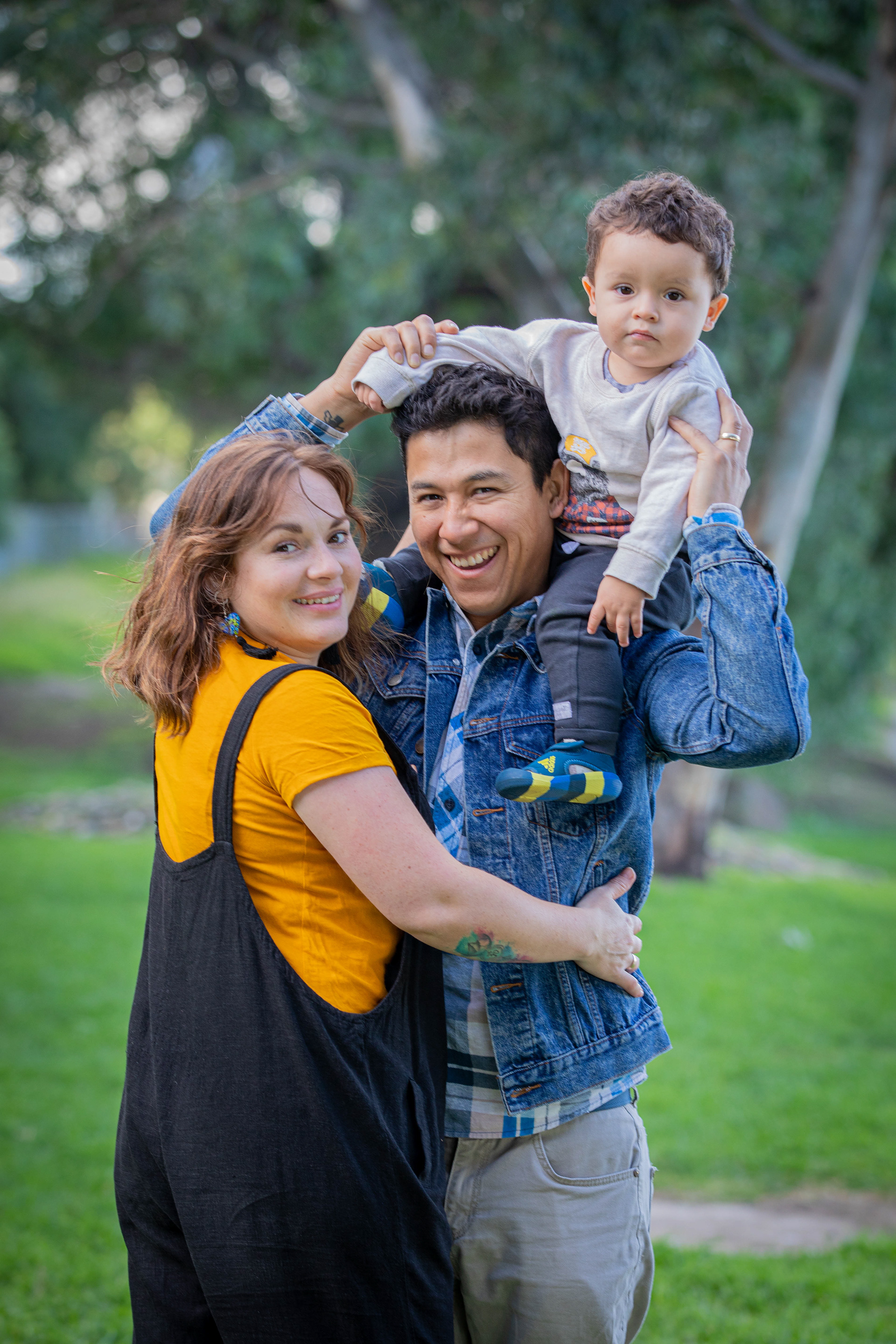 Parent carrying a child on their shoulders outdoors