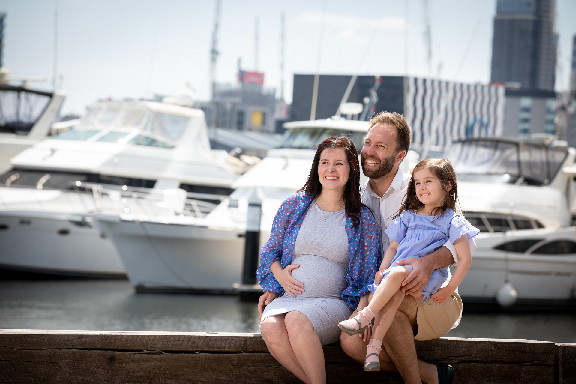 Parent holding a child beside the waterfront