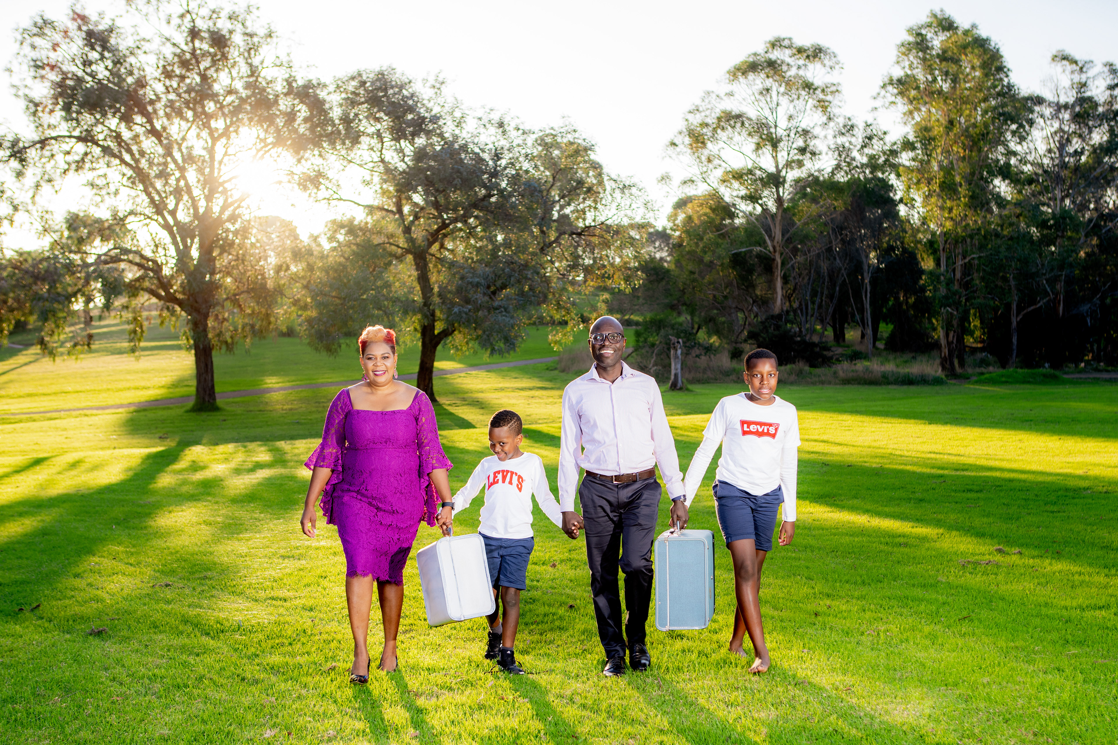 Group portrait walking together across a green lawn
