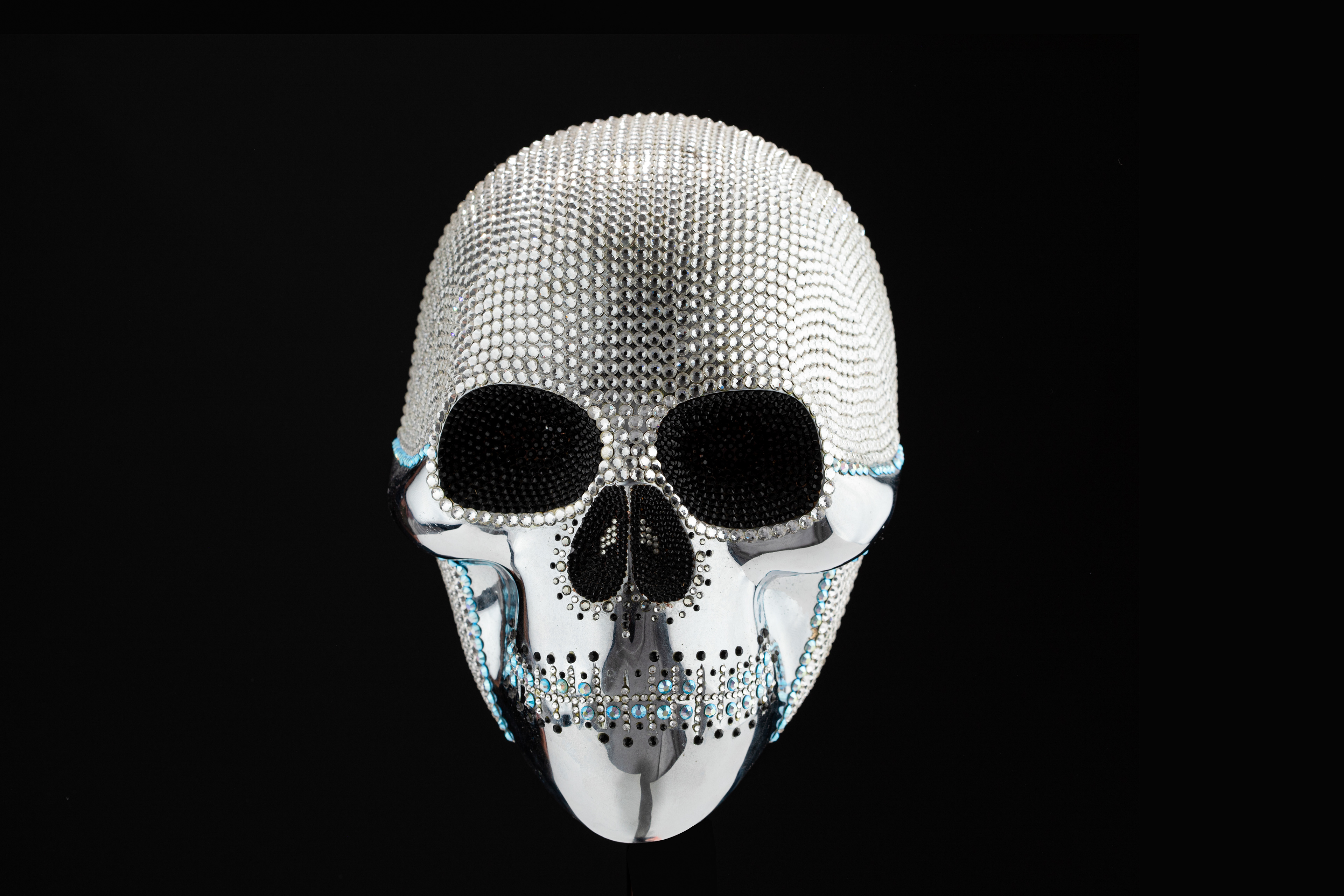Front view of a white beaded skull sculpture