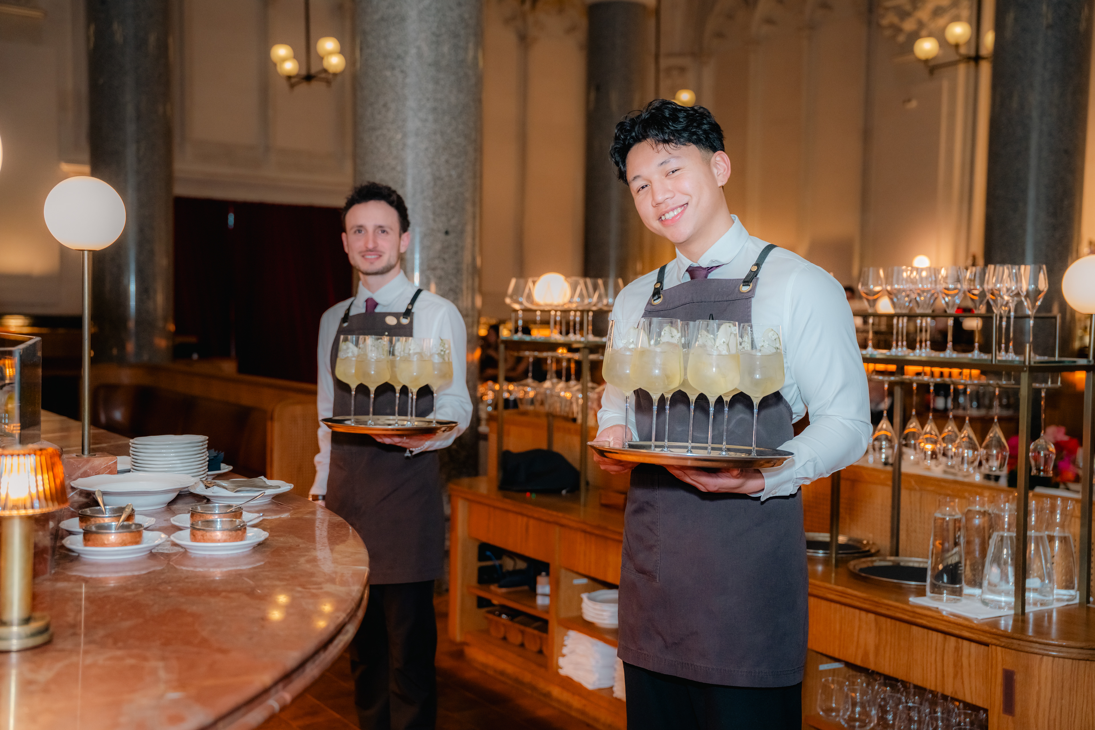 Two restaurant staff members in a dining room