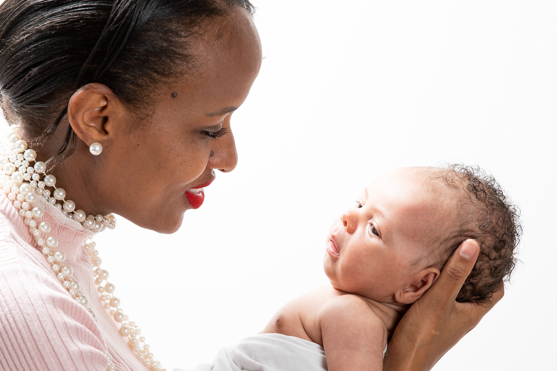Parent embracing a small child in a close-up portrait