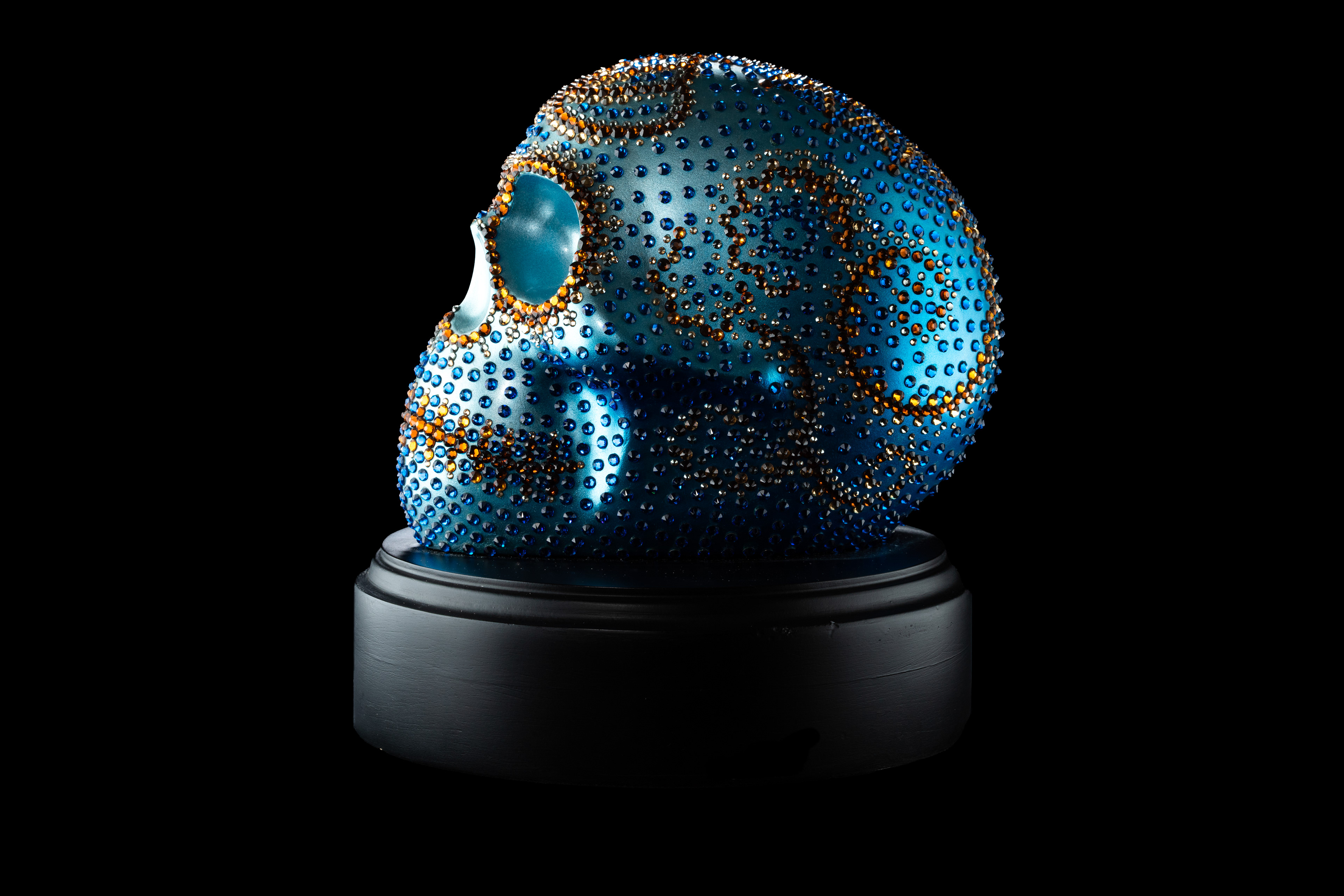 Blue beaded skull sculpture in profile