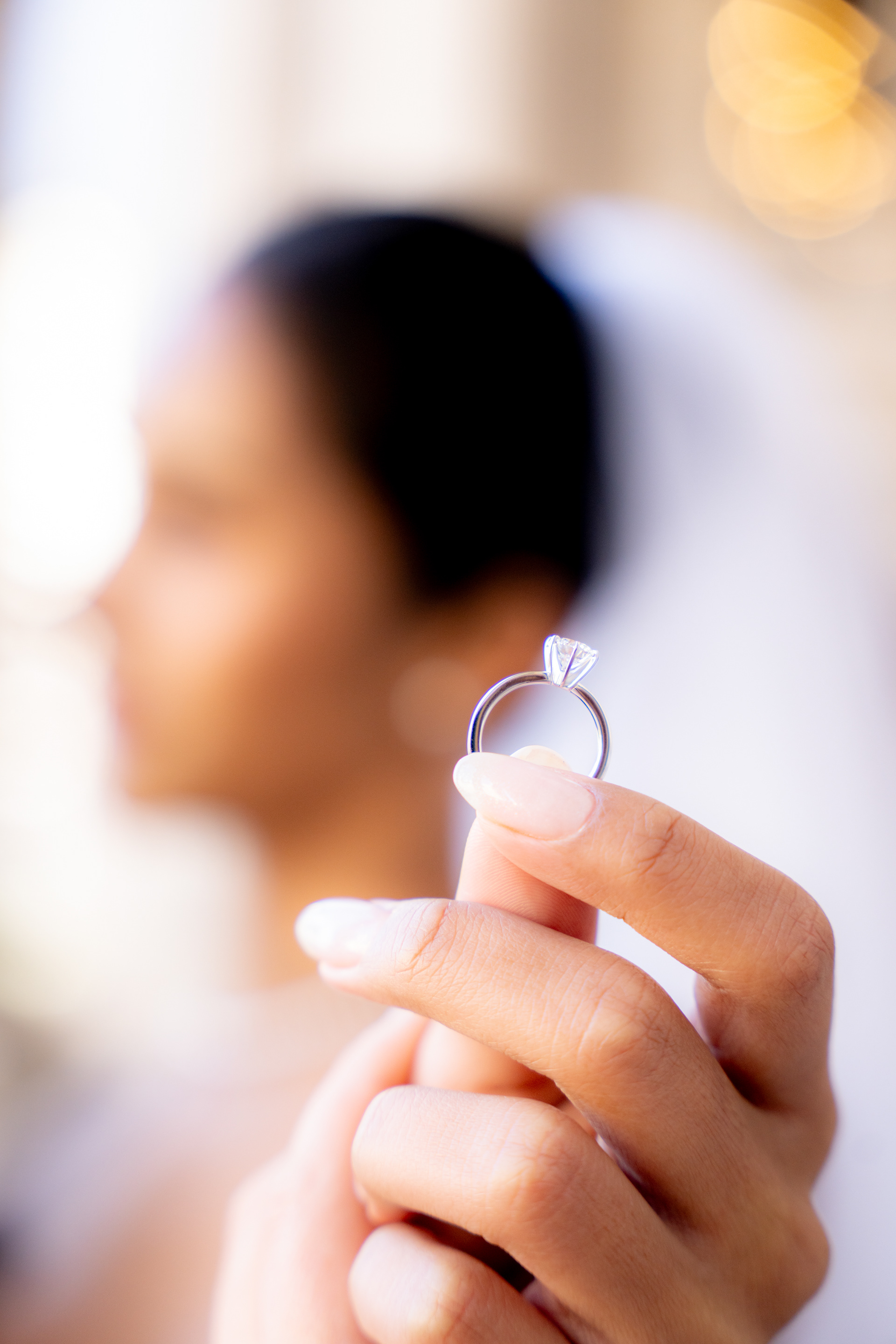 Close-up of an engagement ring held towards the camera