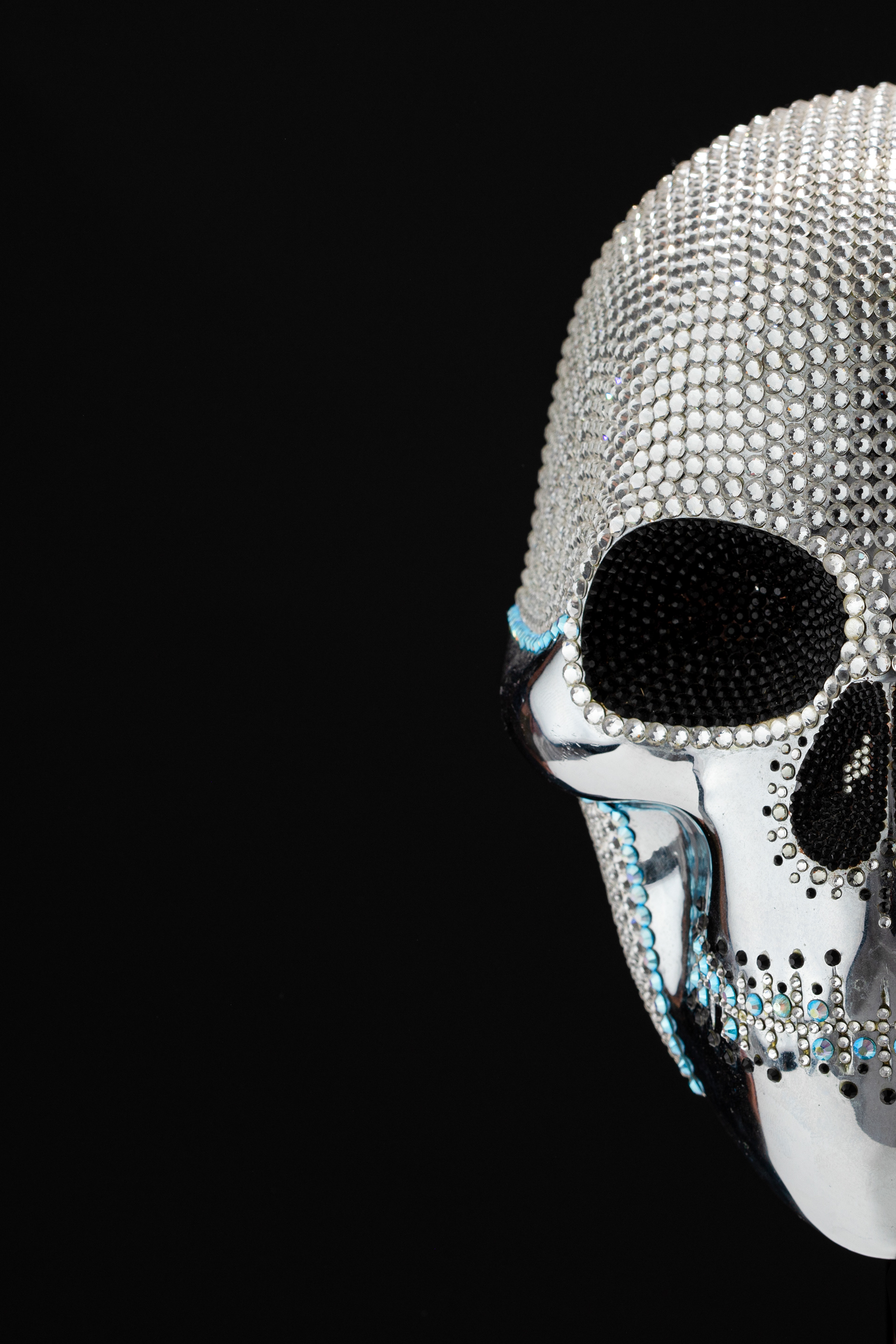 Angled view of a white beaded skull sculpture