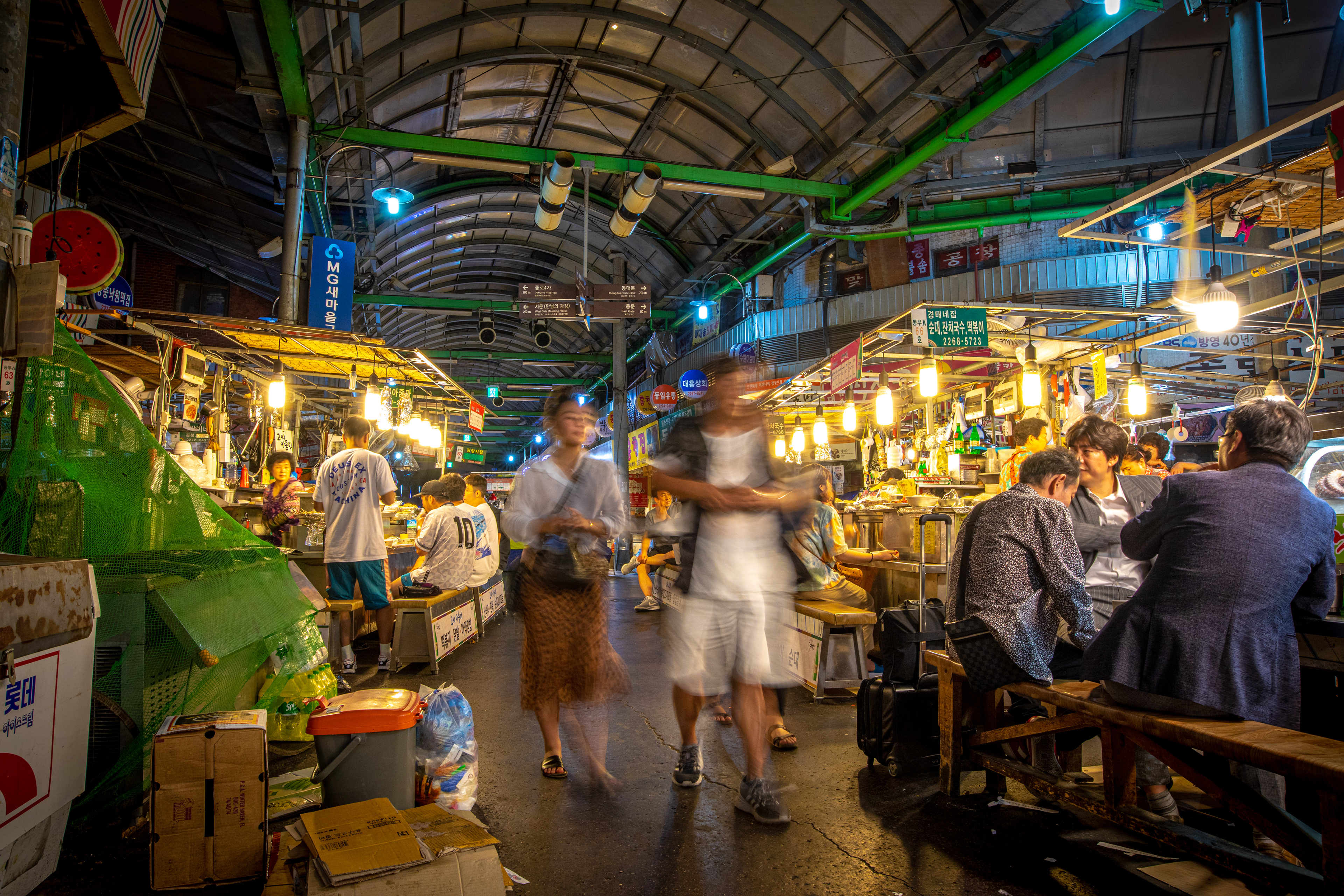 Covered market alley illuminated at night