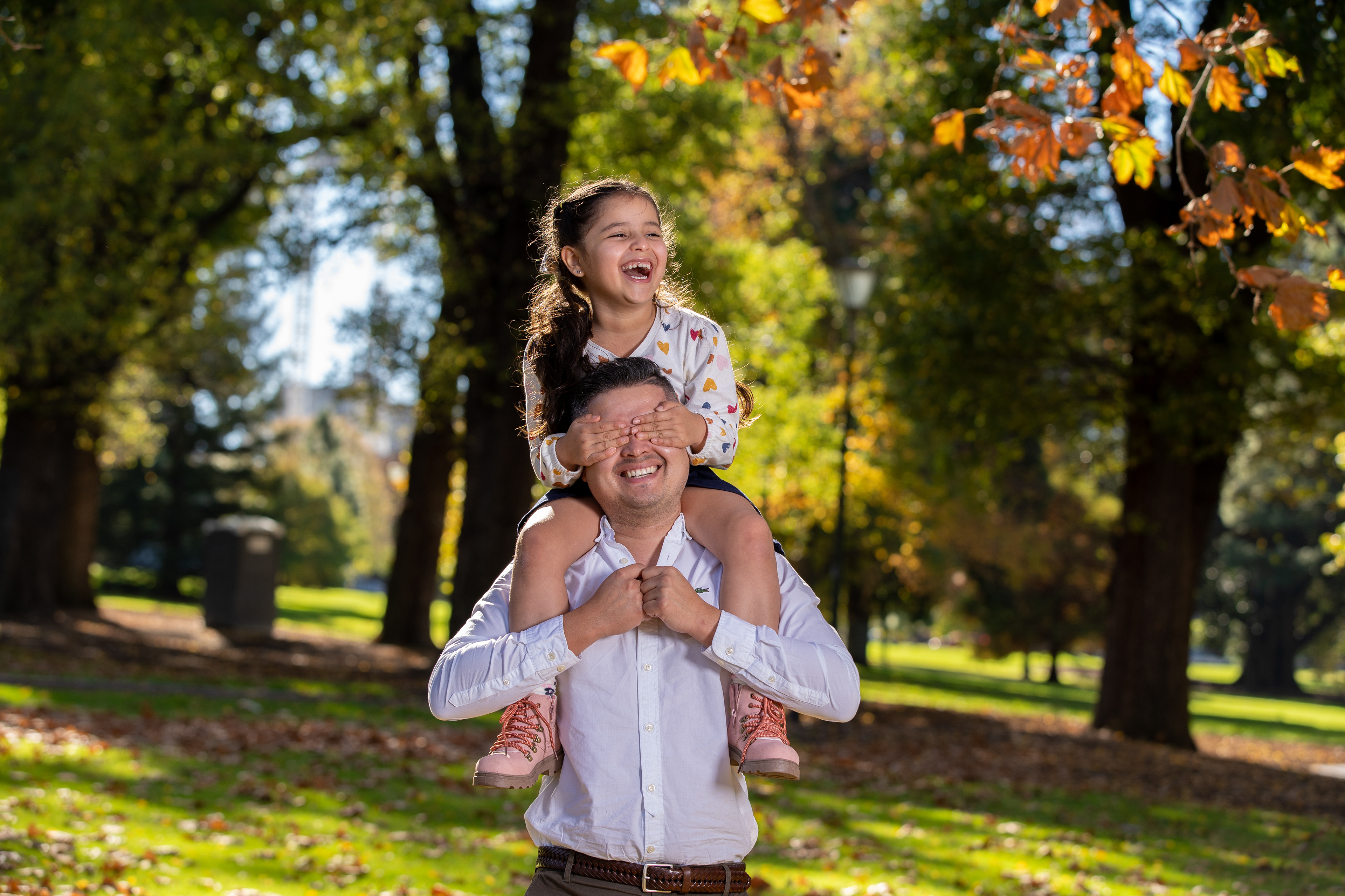 Outdoor portrait in a white dress beneath autumn trees
