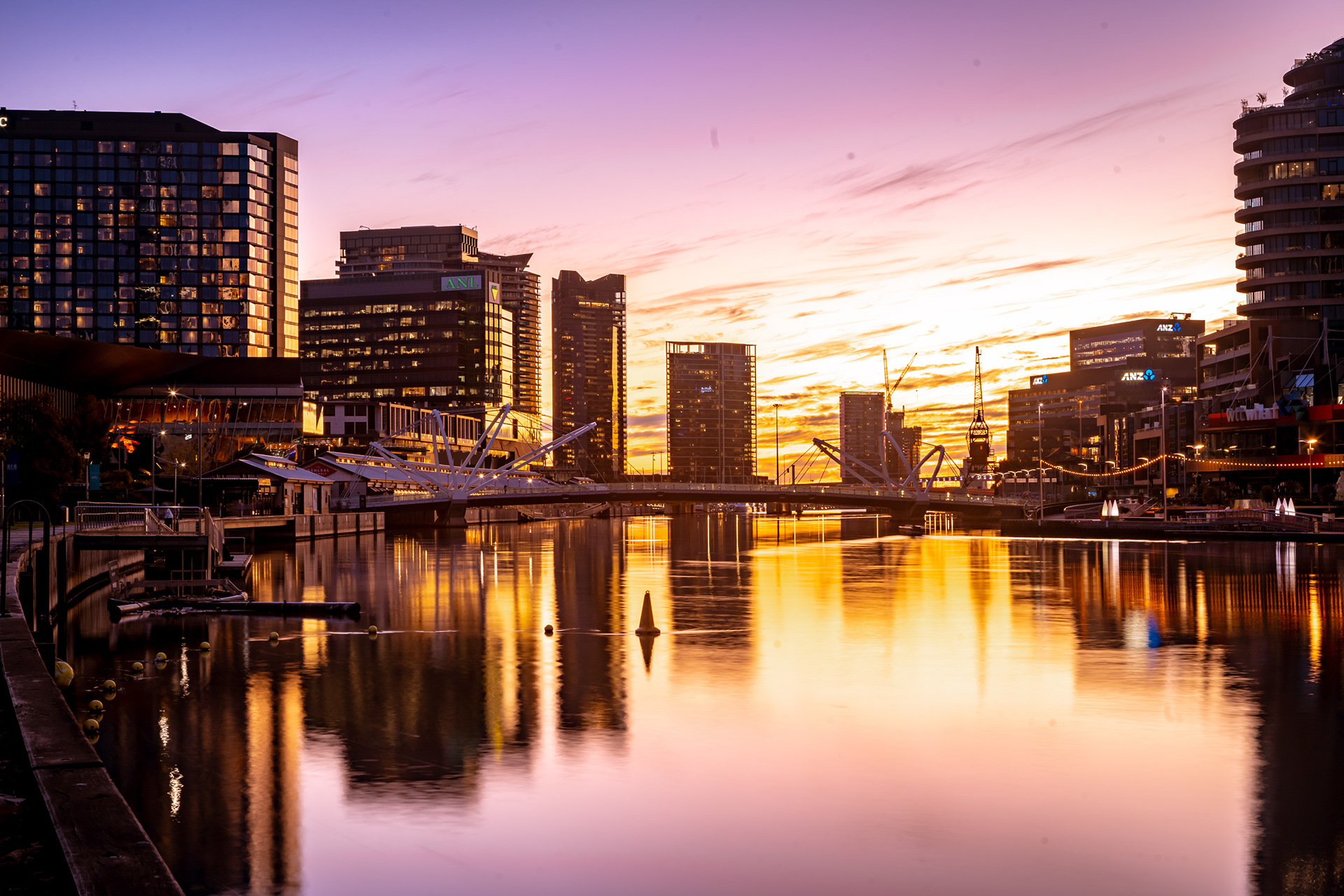 Golden sunset reflected between waterfront apartment buildings