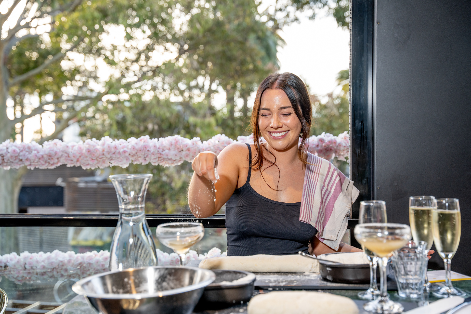 Guest holding a wine glass at an outdoor restaurant table