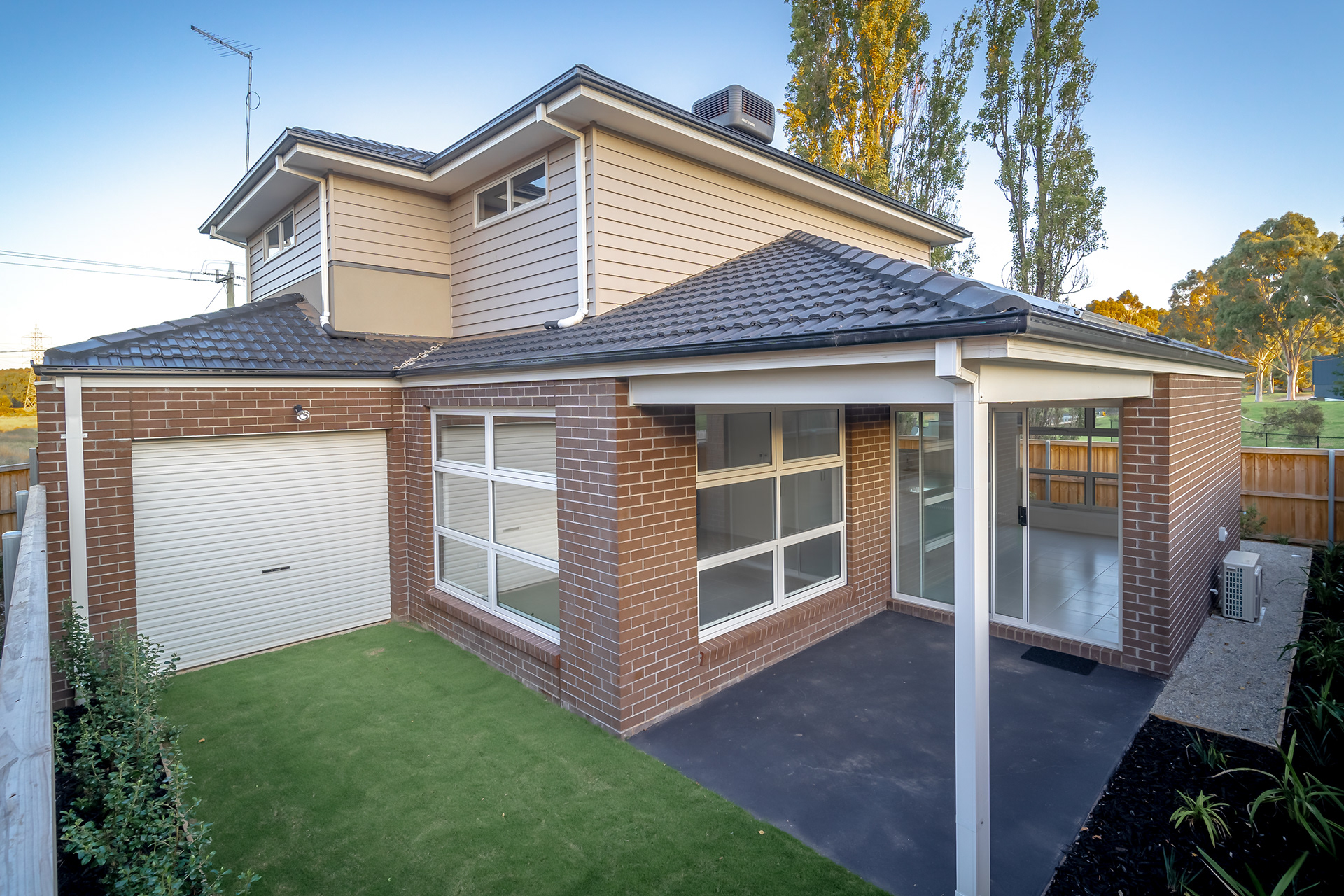 Exterior of a two-storey brick house with a garage