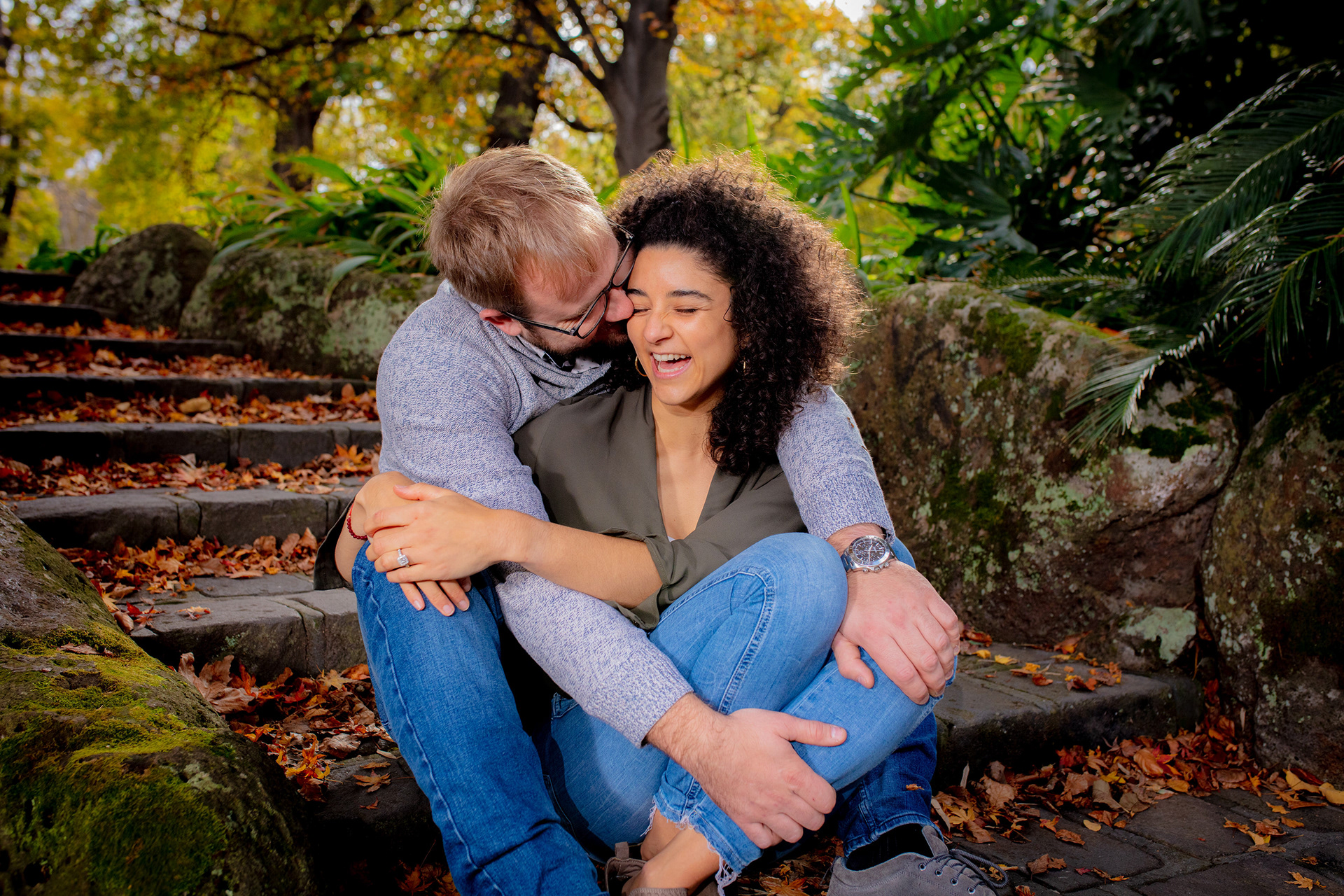 Couple sitting close together on a garden bench