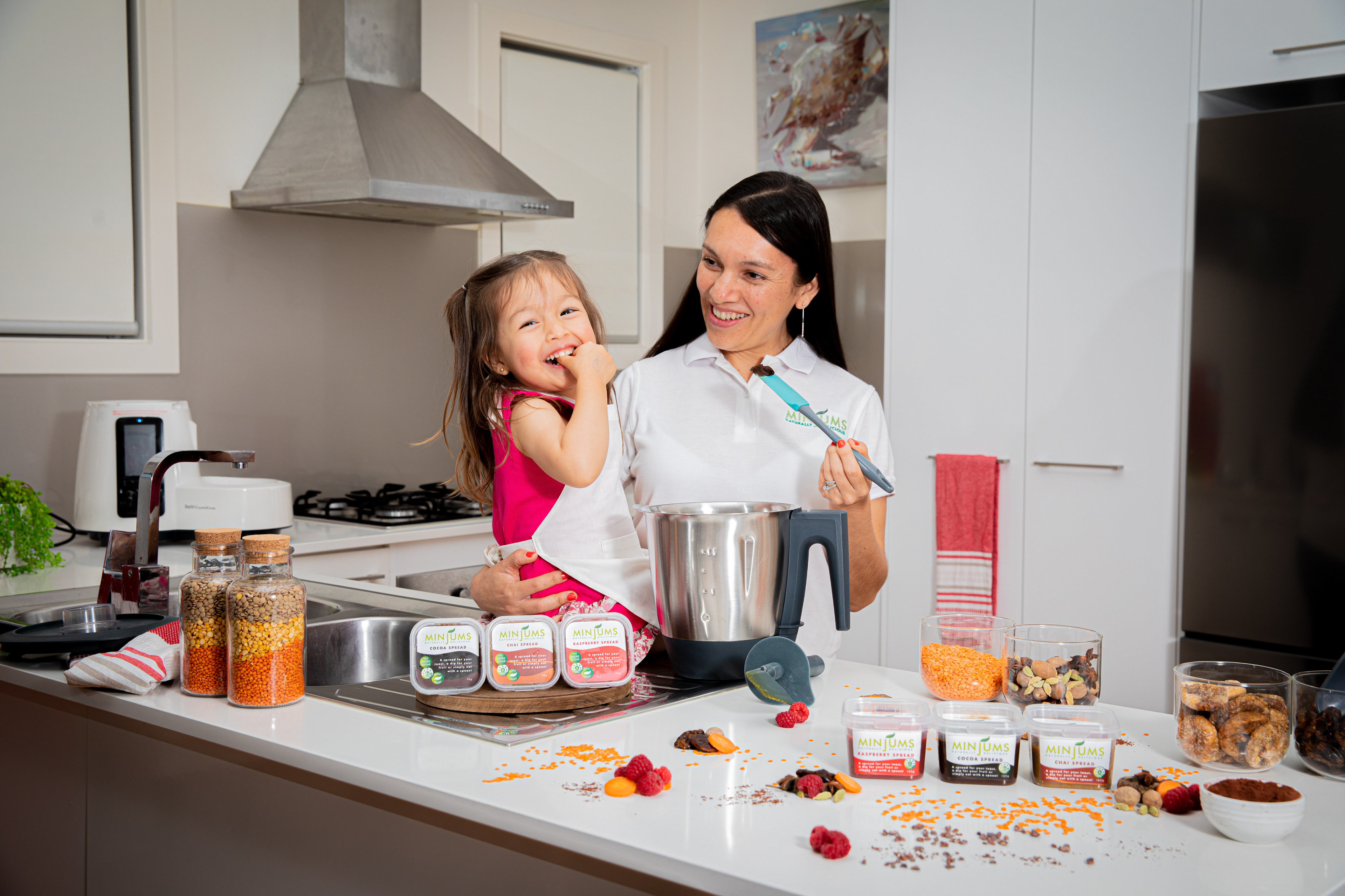 Parent and child beside a birthday cake at home