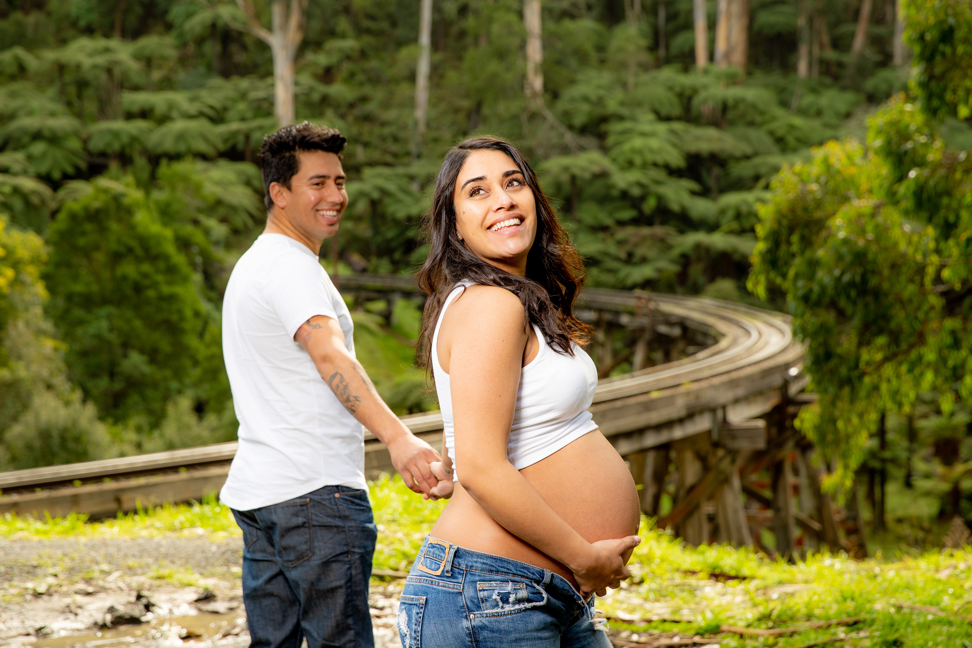 Couple posing together during an outdoor maternity session