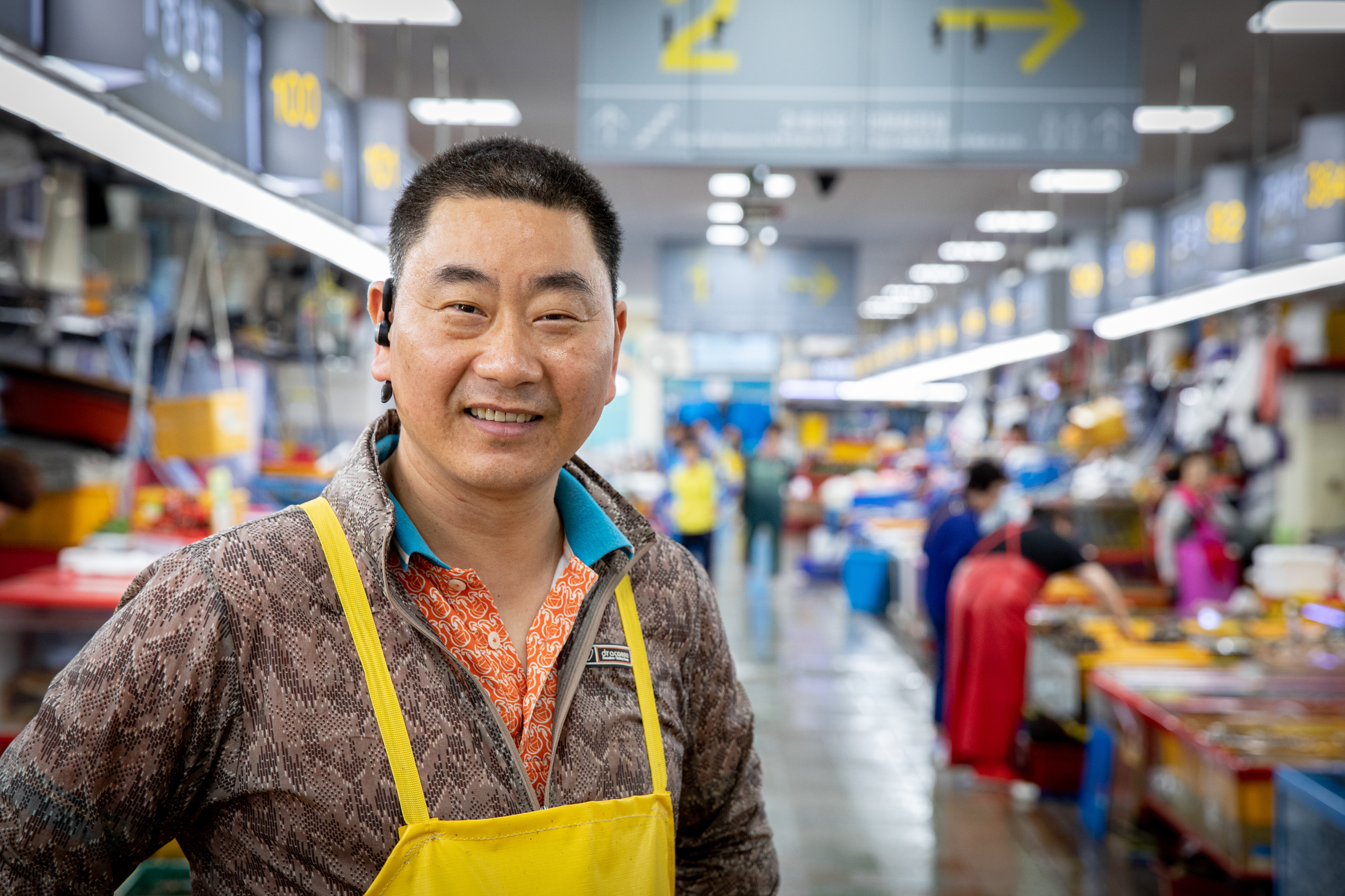 Smiling seafood vendor wearing an apron
