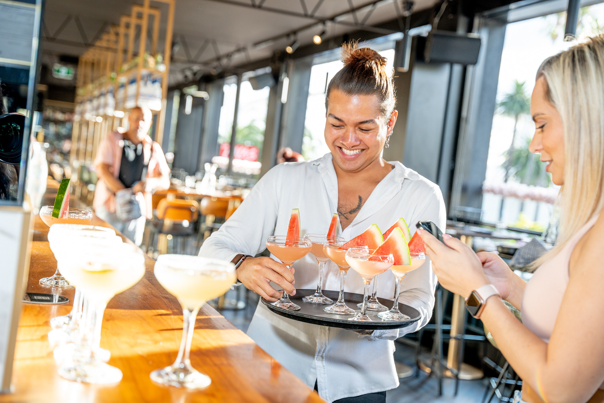 Waiter serving food to a guest at a restaurant table