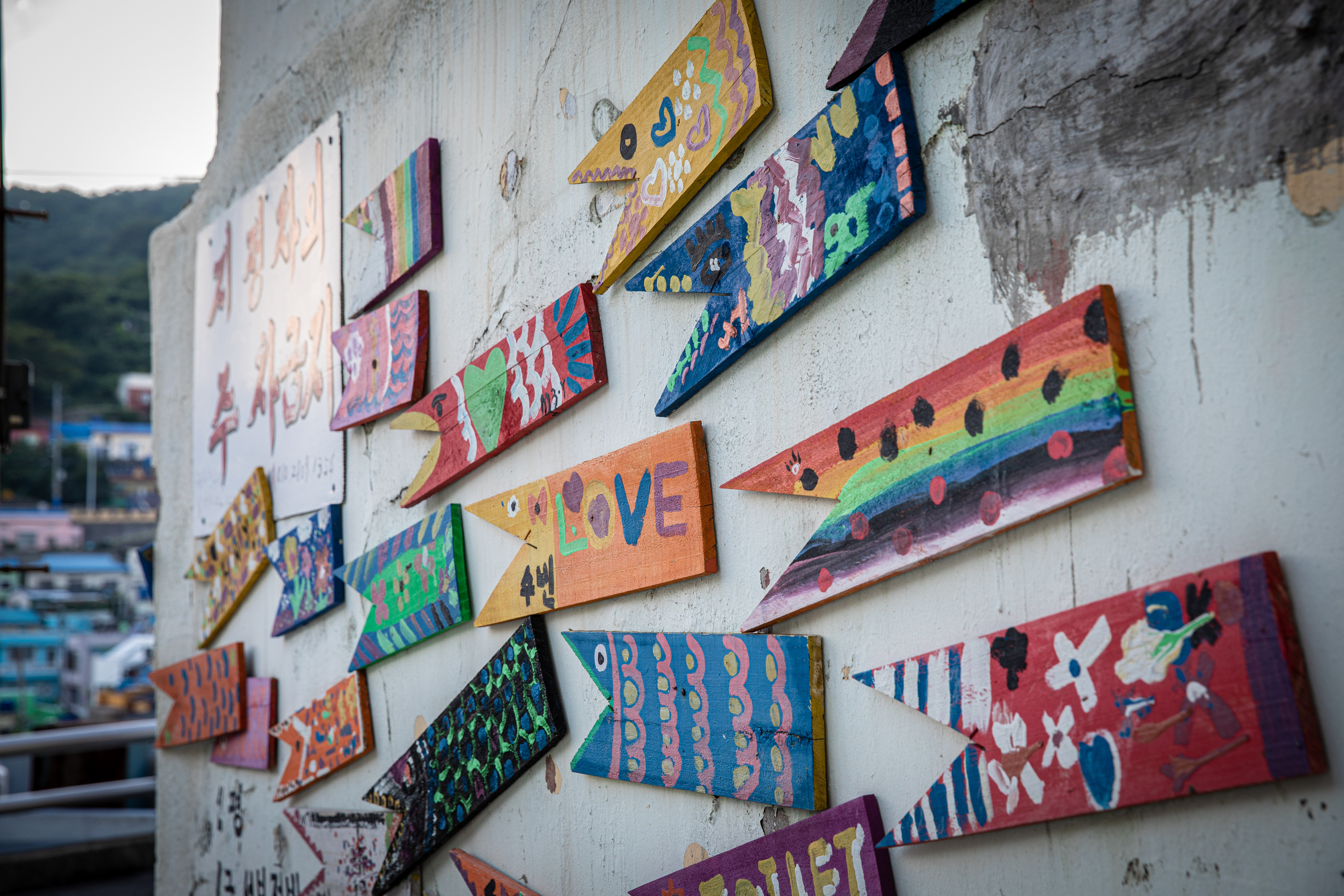 Decorative signs attached to a colourful neighbourhood wall