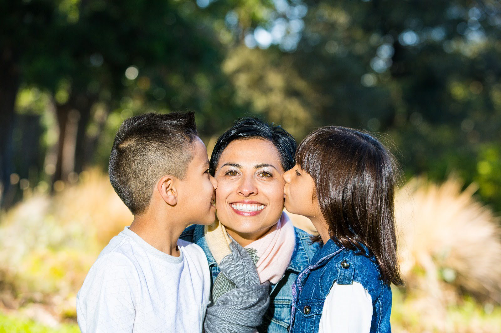 Children kissing a parent on both cheeks