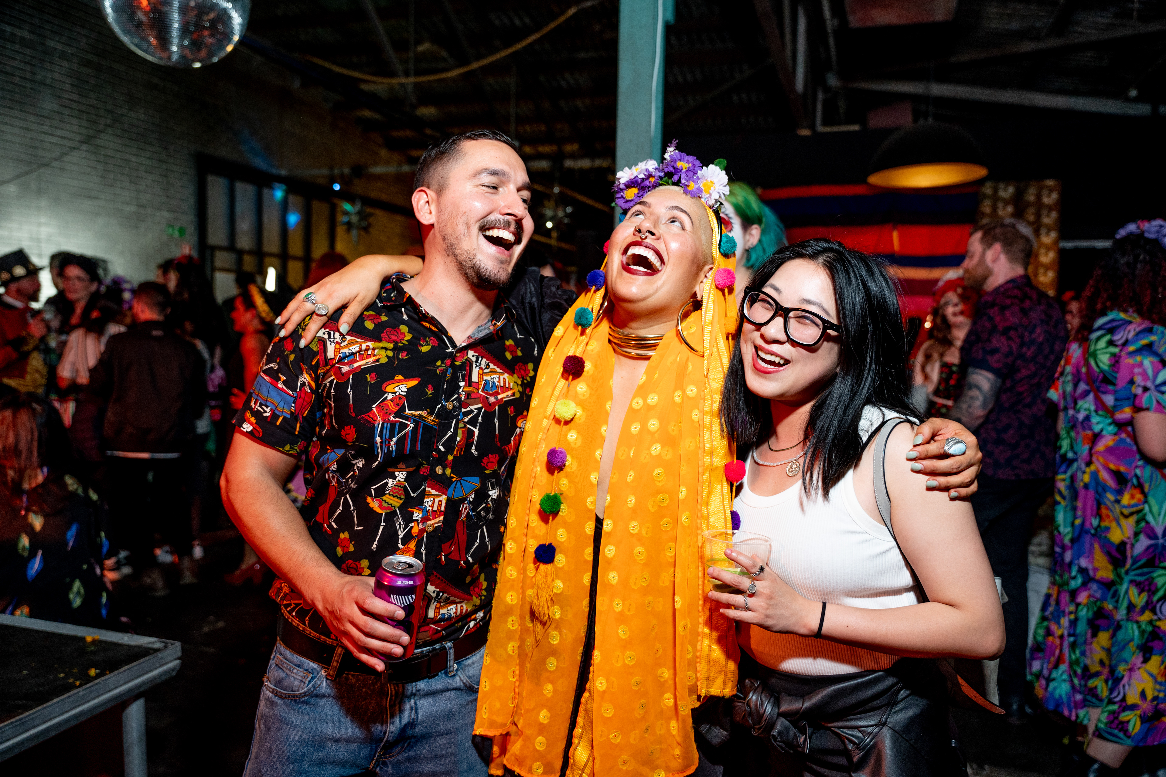 Guests laughing together at a colourful evening celebration