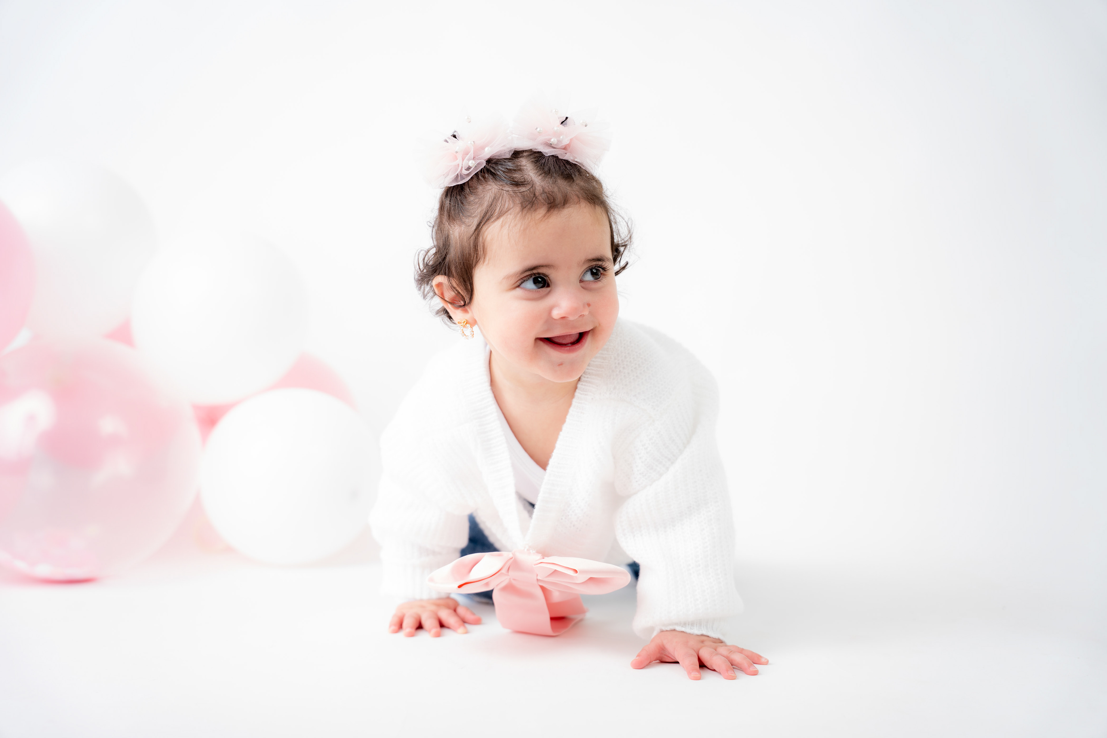 Baby portrait against a soft pink background