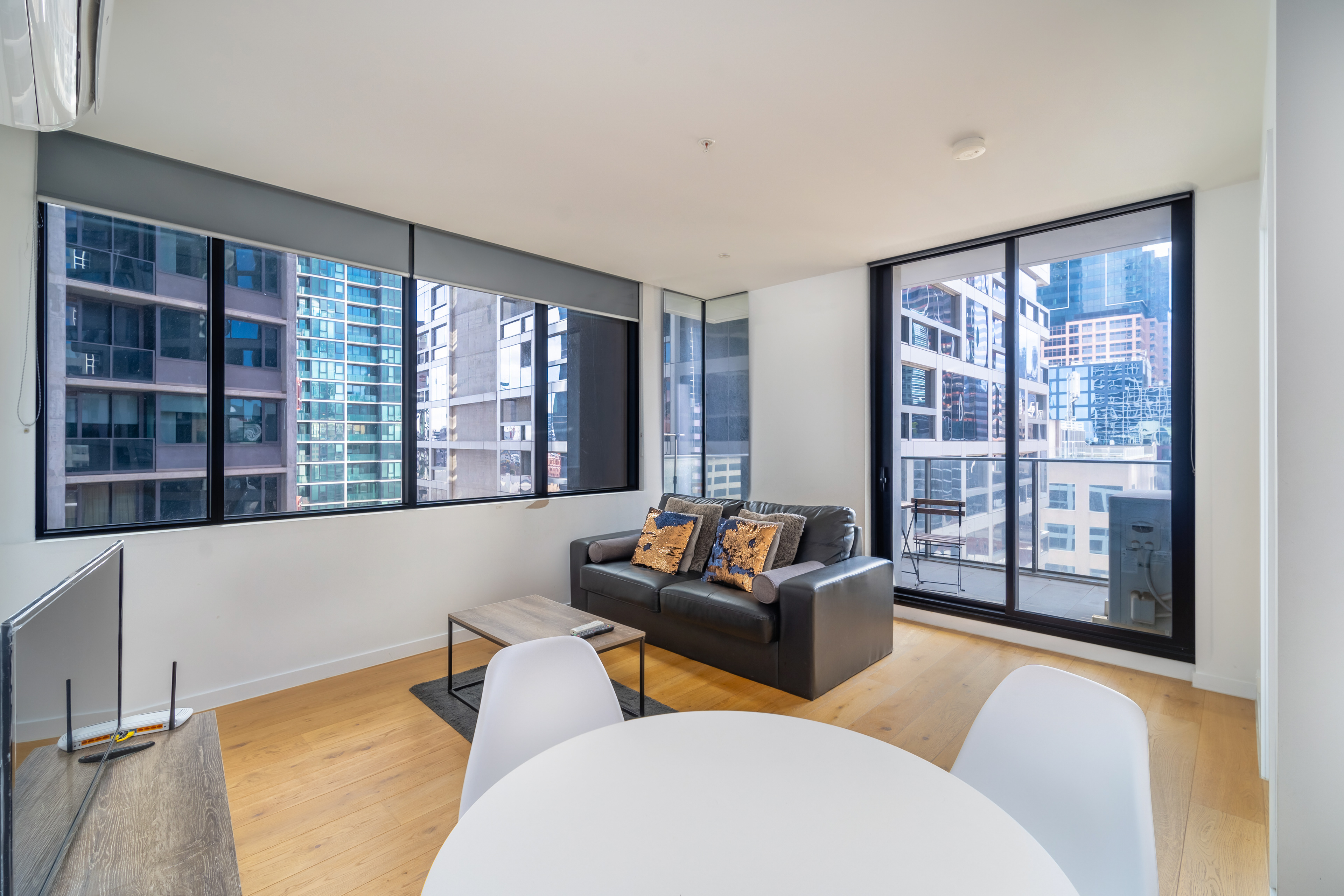 Corner apartment living room with wraparound city windows