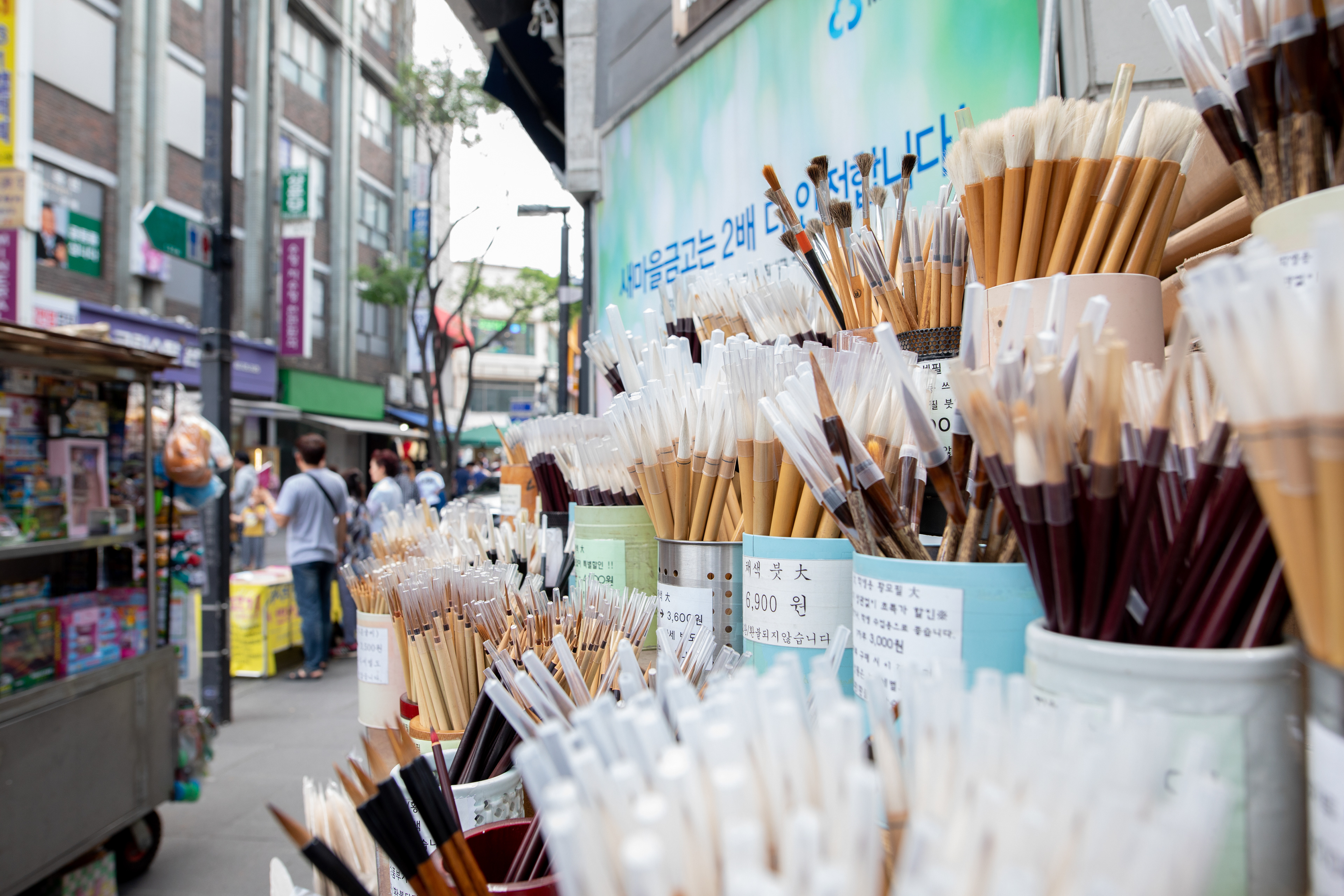 Paintbrushes displayed outside an art supplies shop