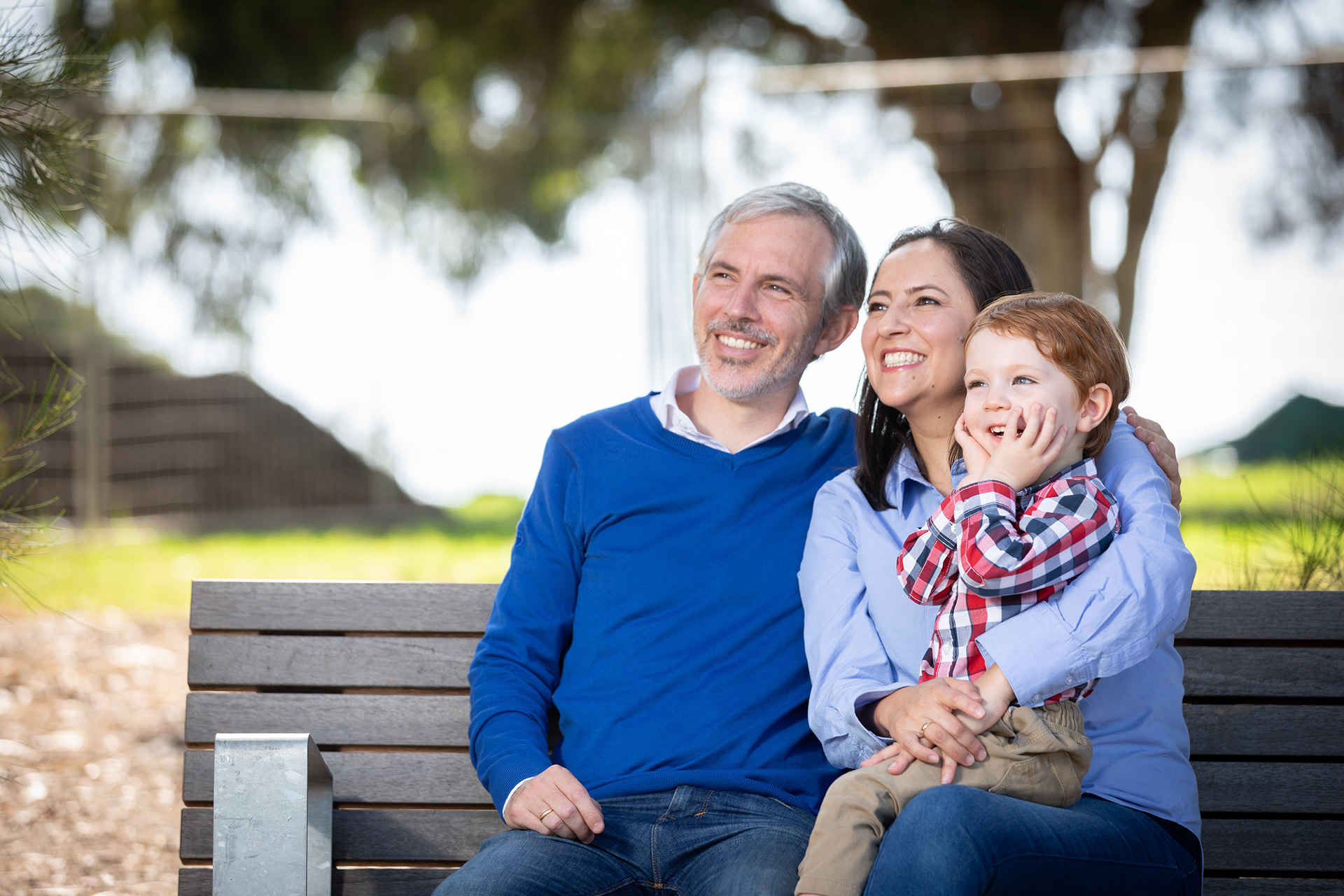 Two adults seated together on a garden bench