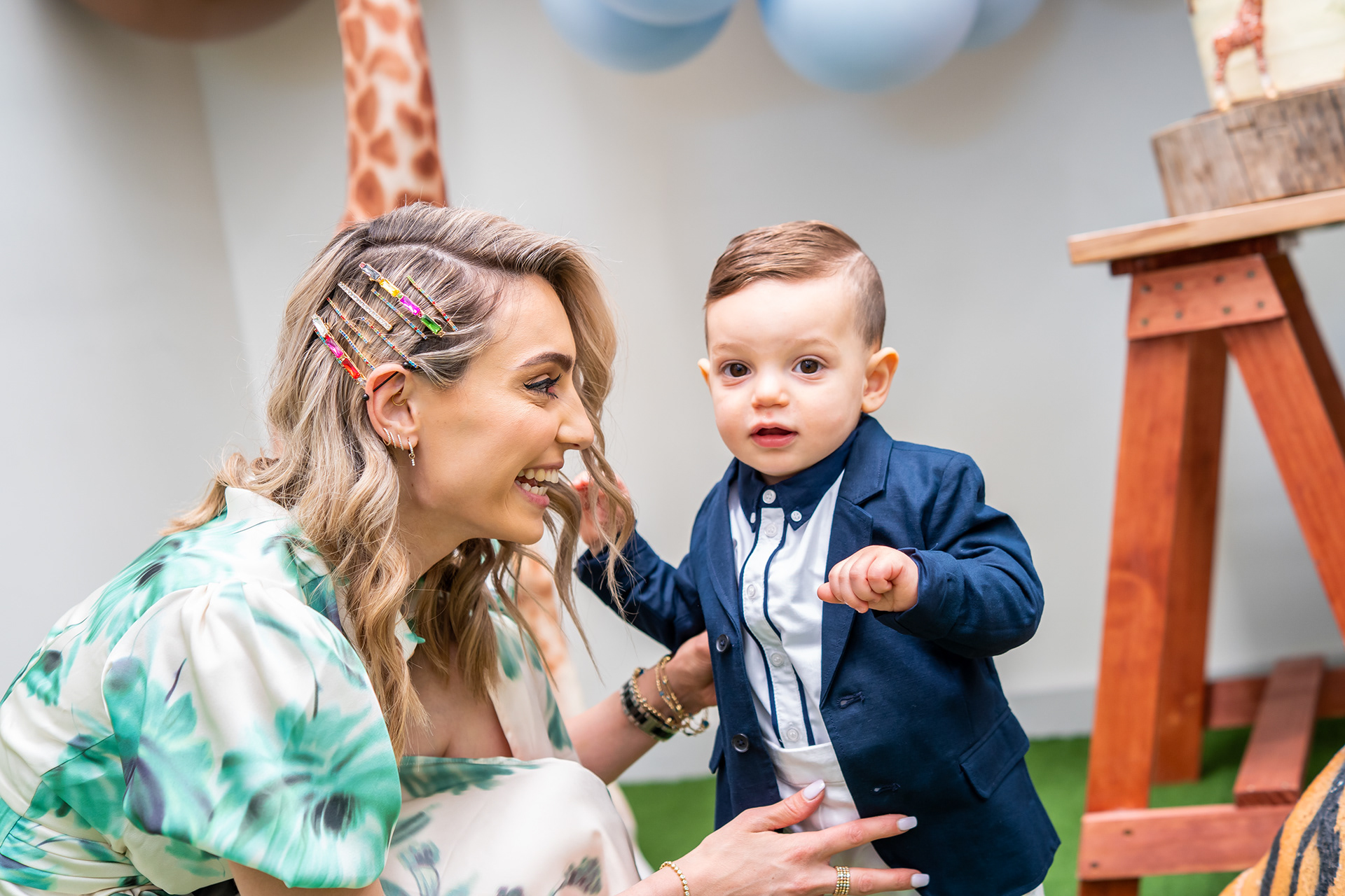 Parent smiling at a young child during a celebration