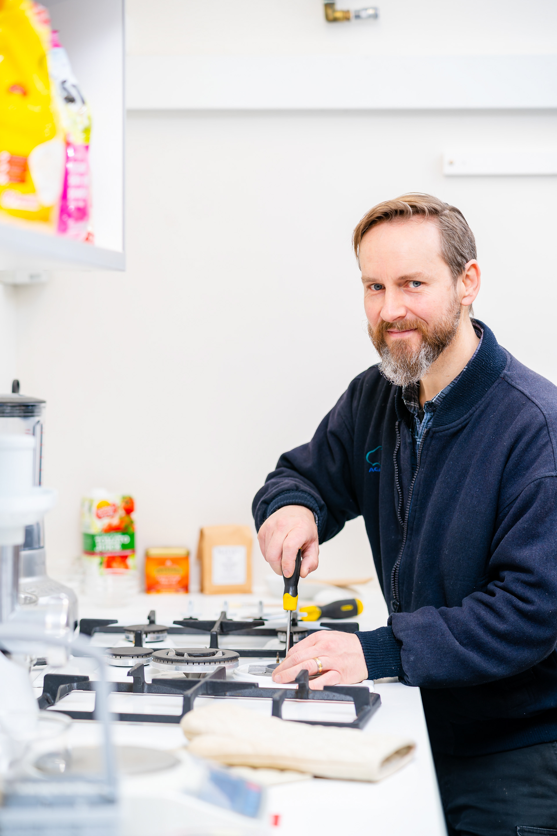 Professional portrait beside a workbench in a bright workspace