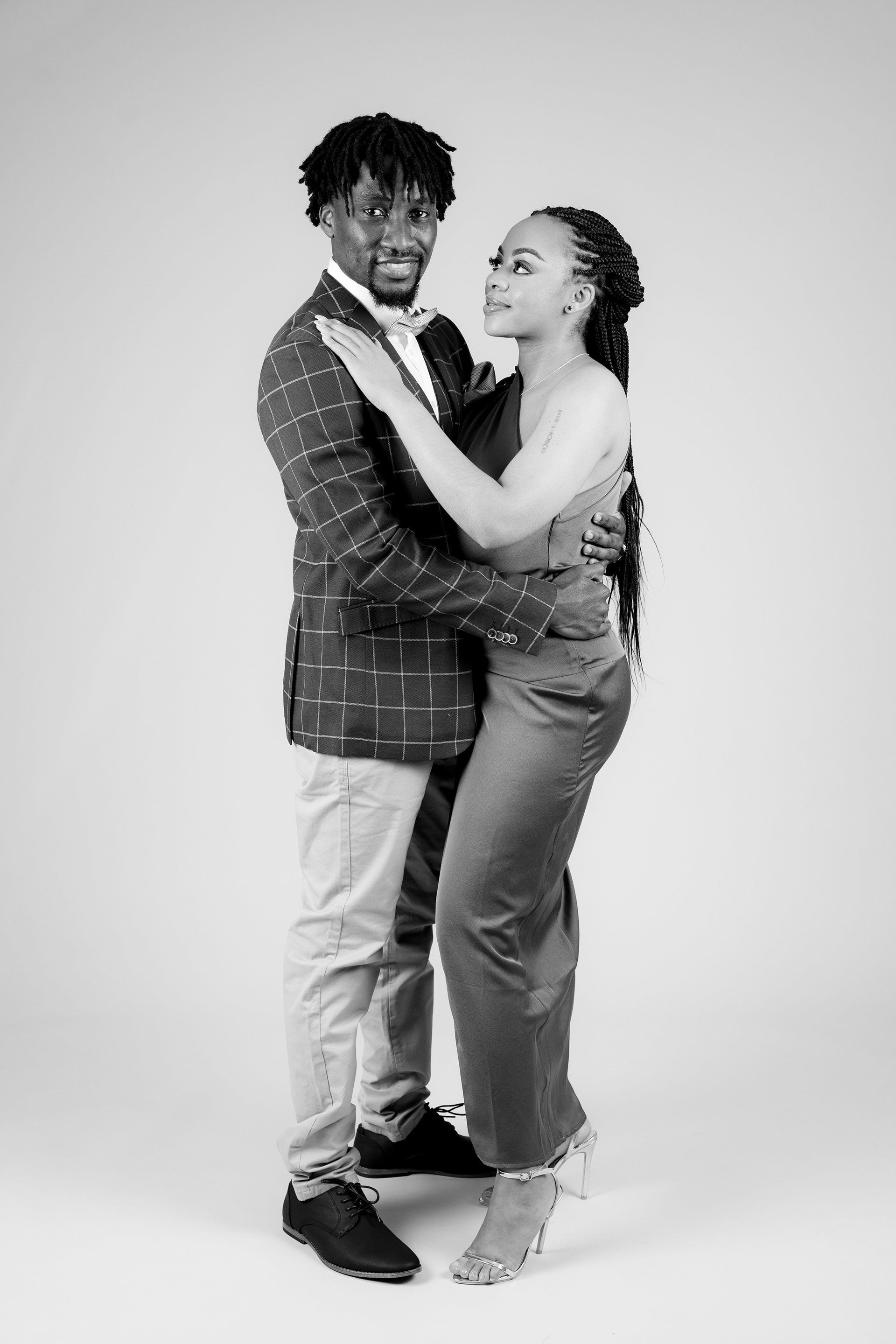 Black-and-white portrait of a couple embracing