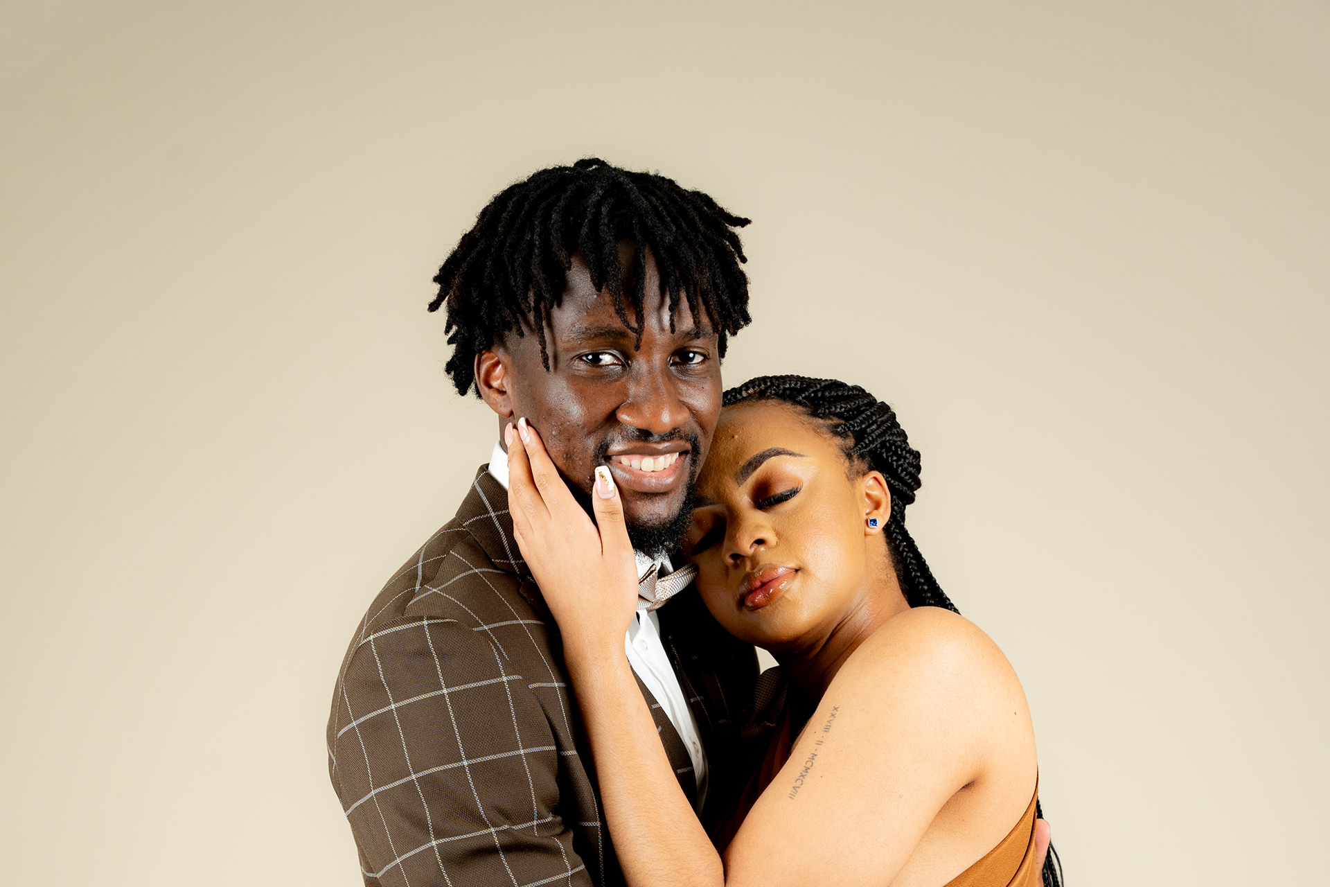 Couple laughing together in a studio portrait