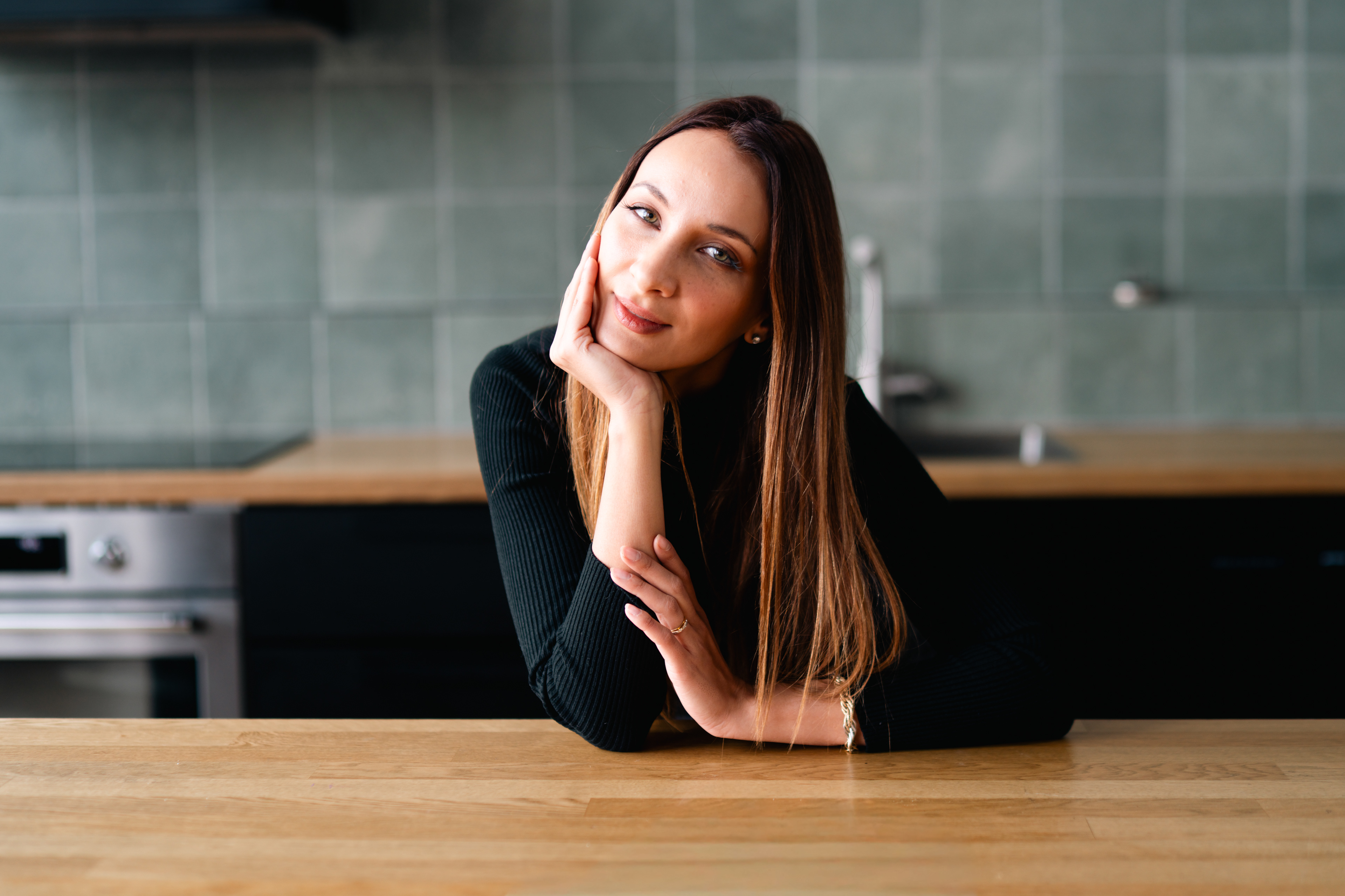 Portrait resting at a wooden kitchen counter