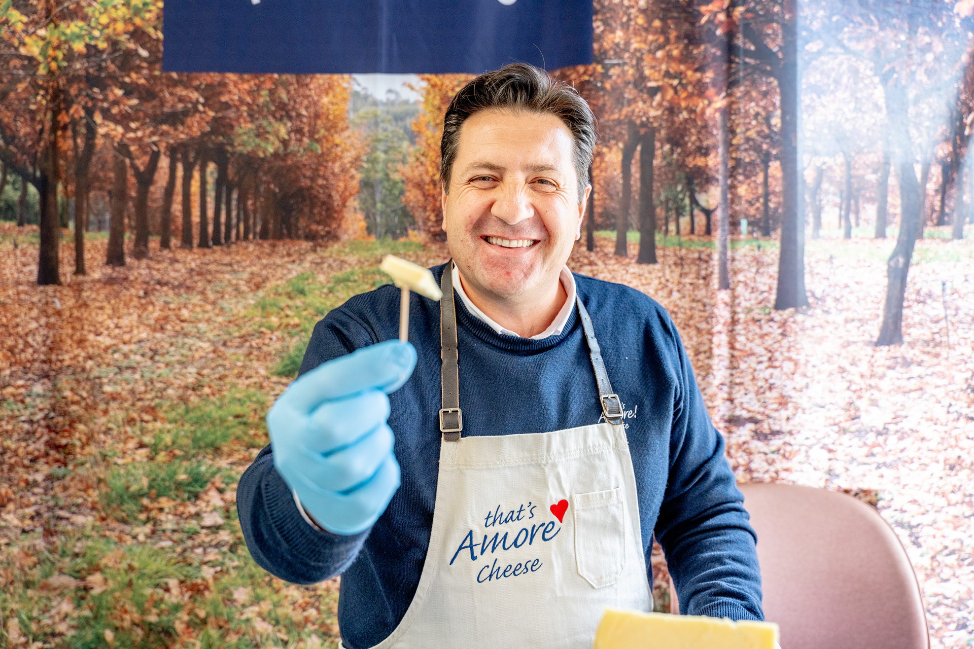 Smiling restaurant staff member holding a serving board