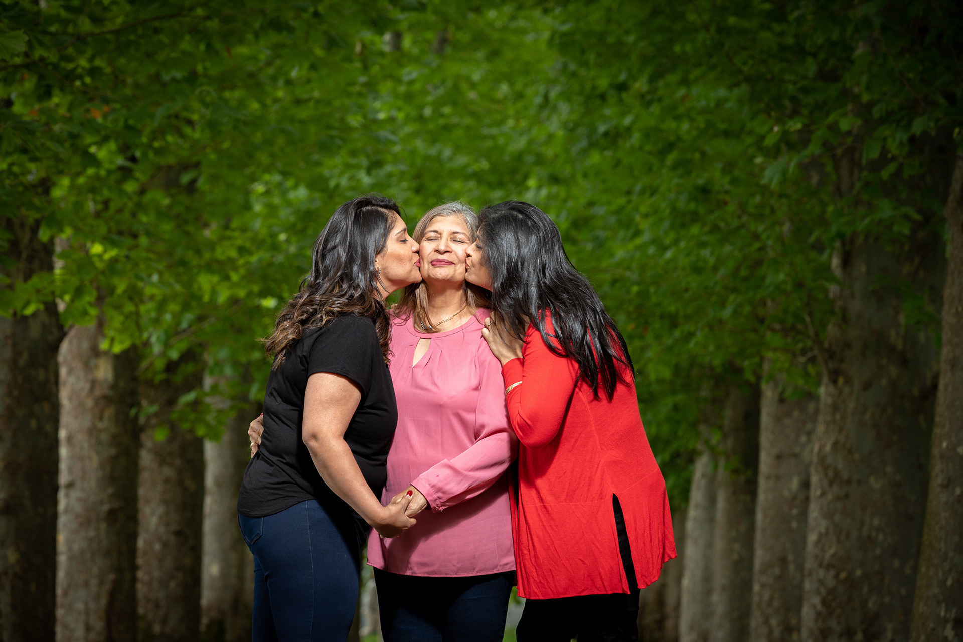 Family portrait beneath leafy trees