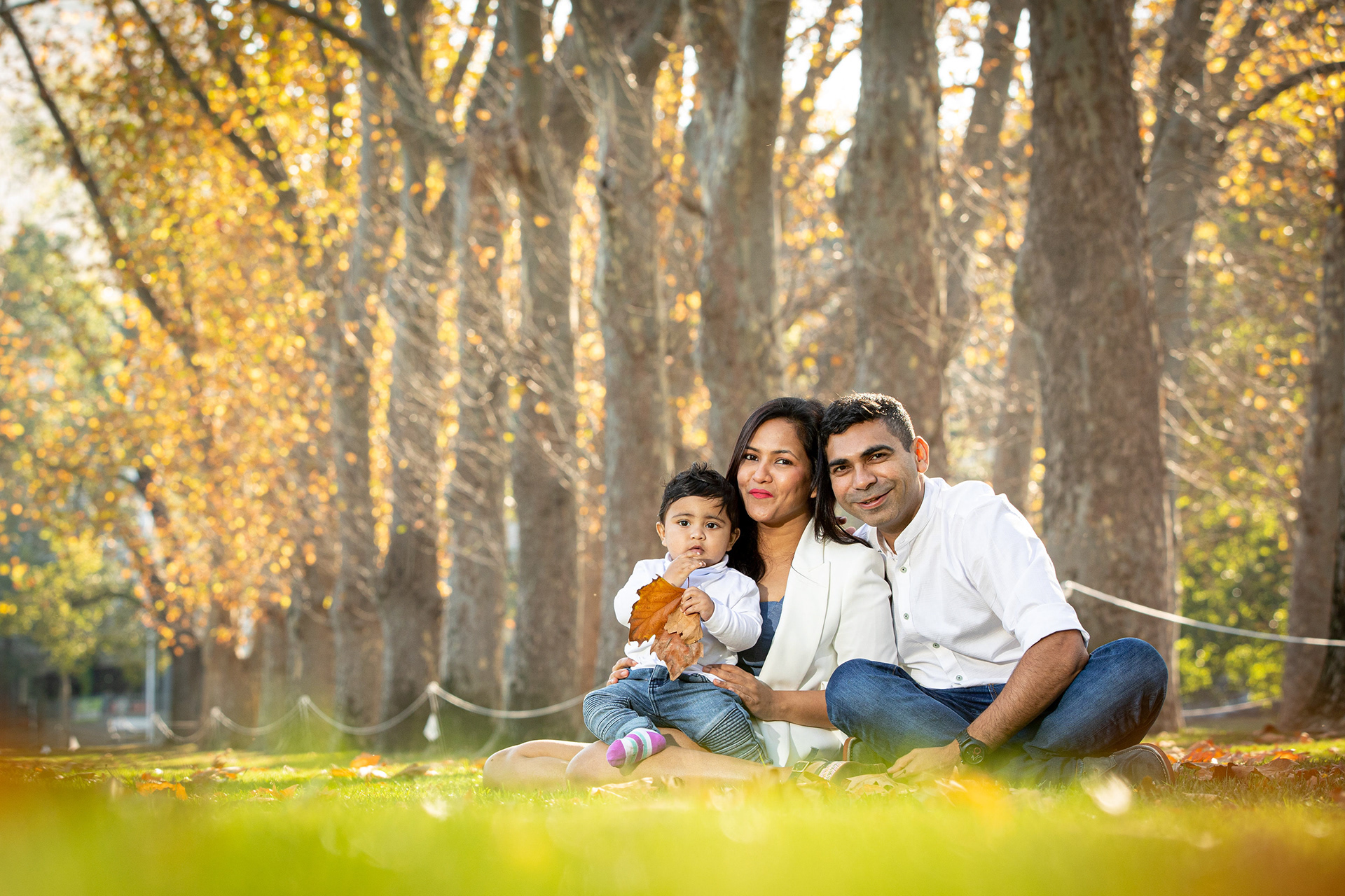 Family sitting together in a sunlit park
