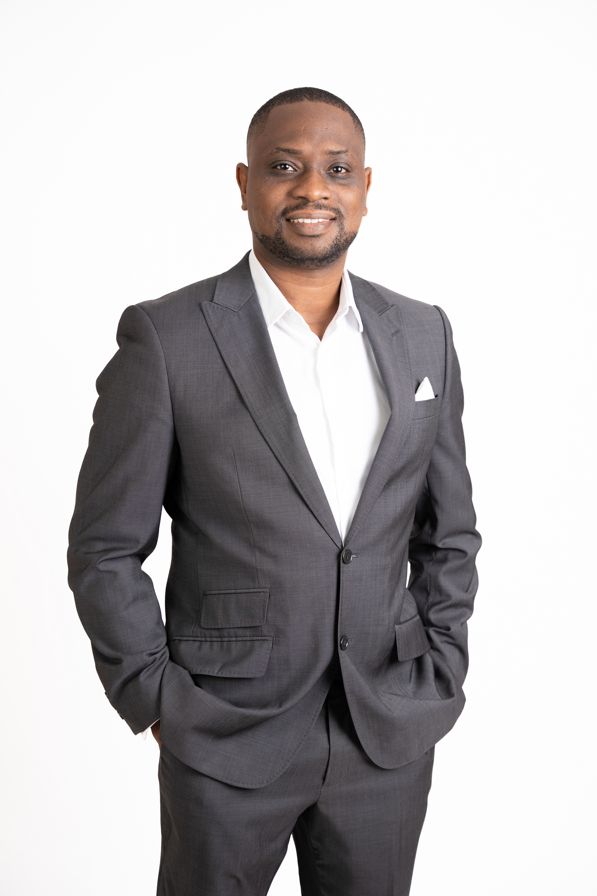 Professional portrait in a dark suit against white