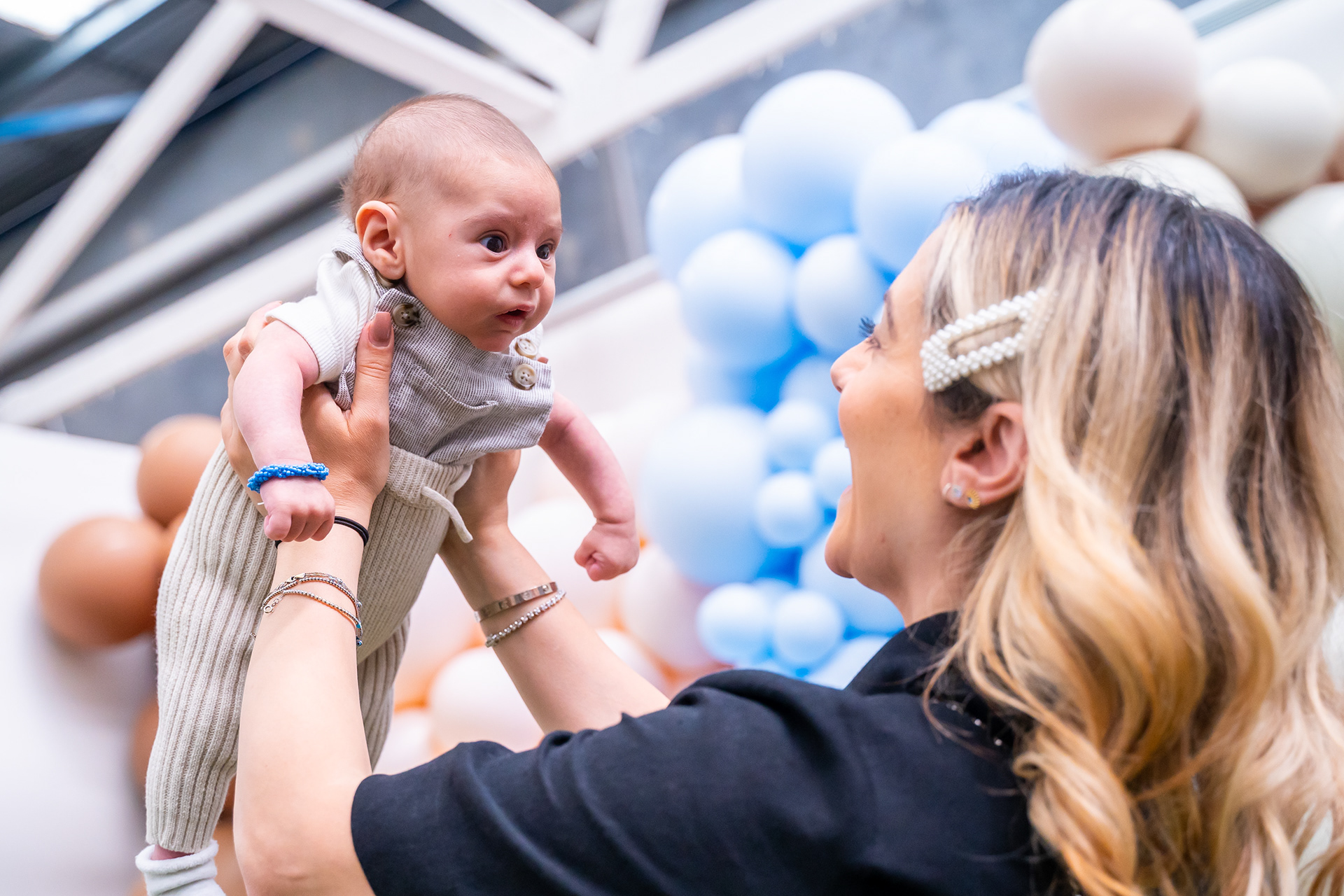 Parent lifting a baby during a family celebration