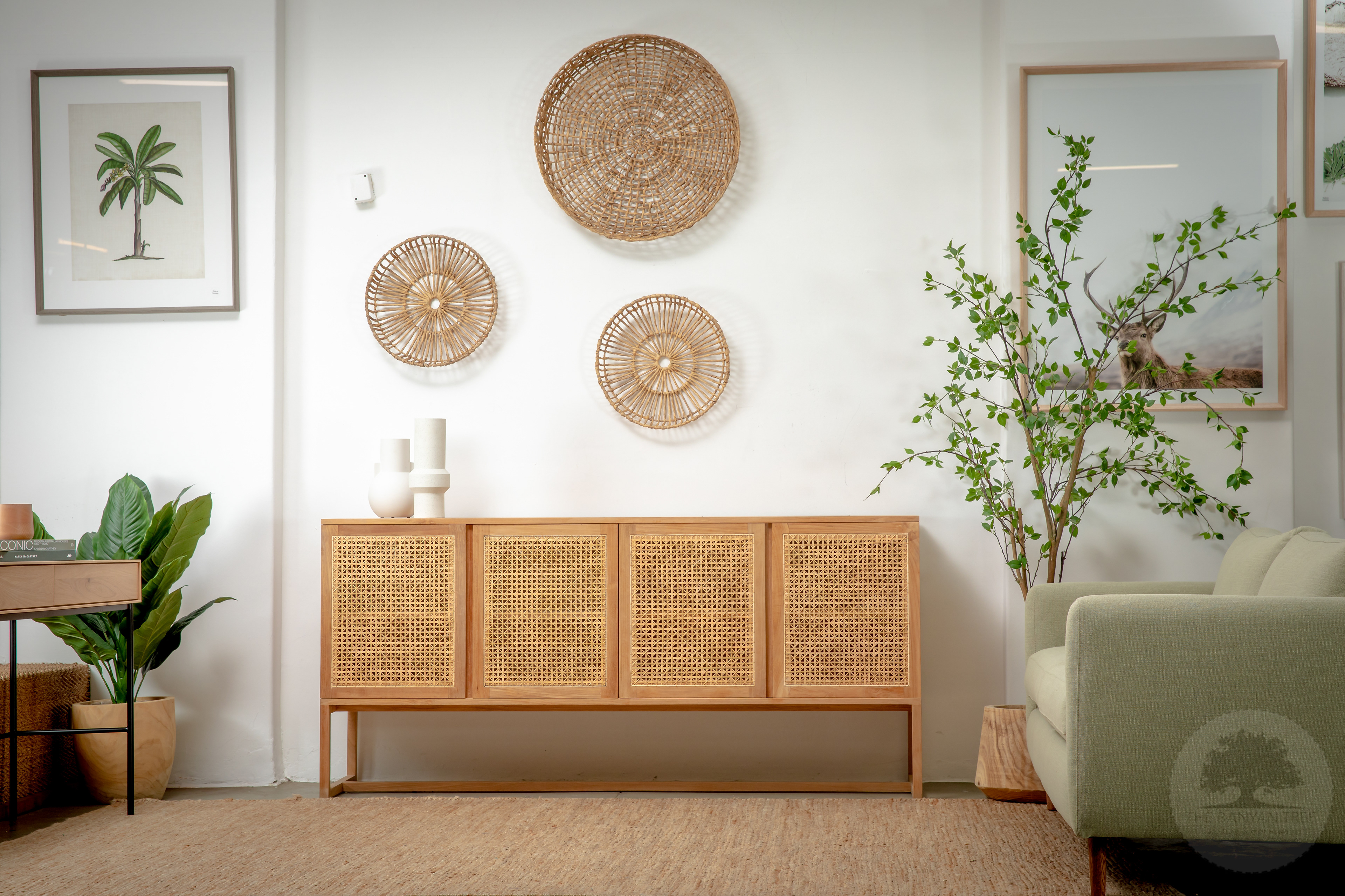 Timber sideboard styled with wall art and indoor plants