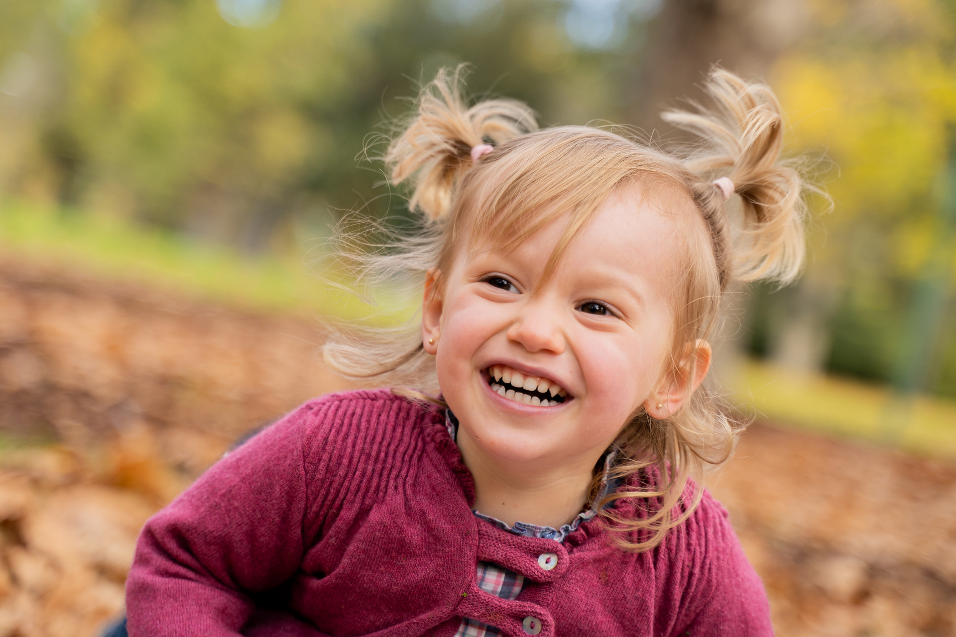 Close-up of a toddler in a burgundy outfit